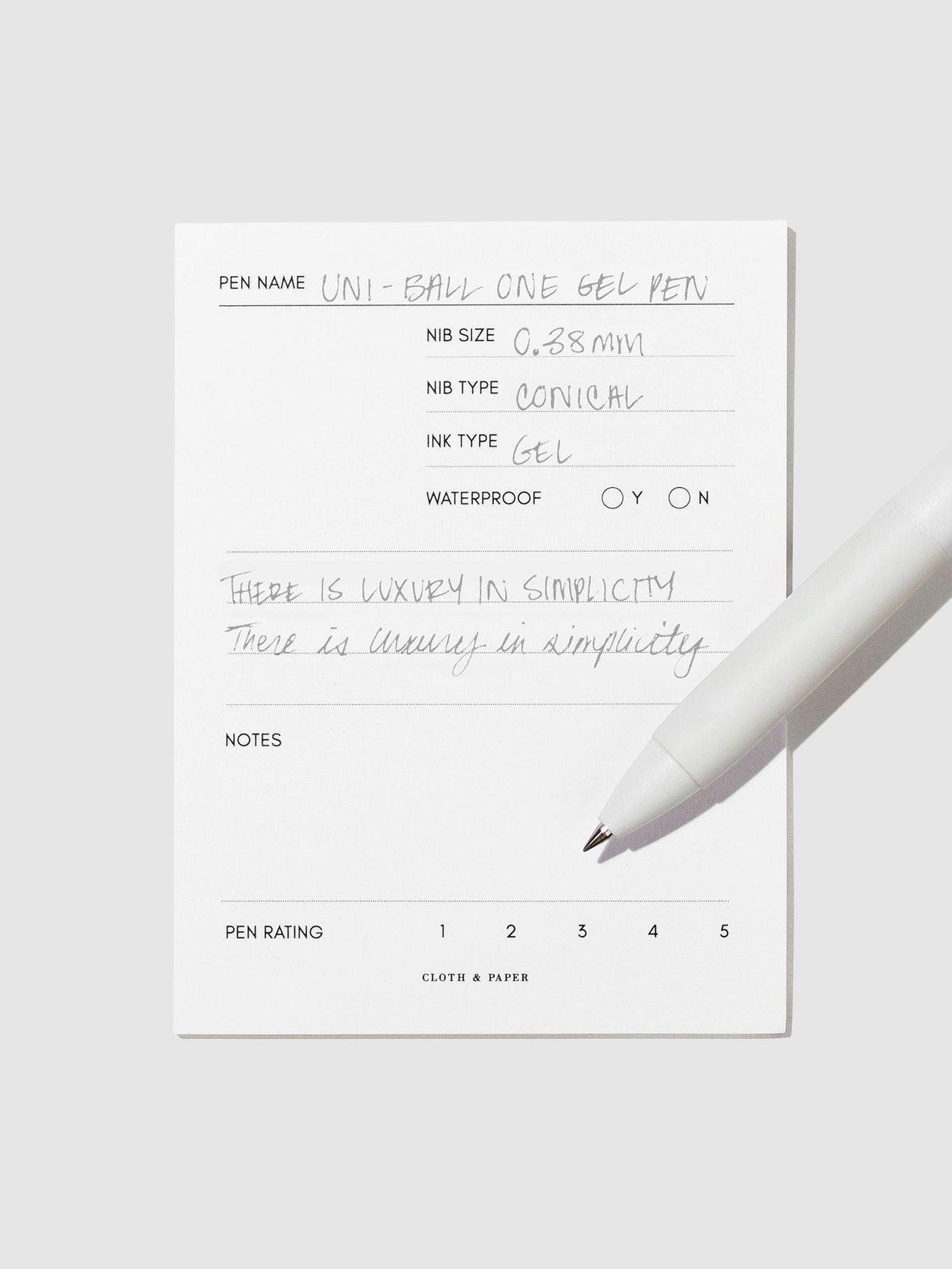 Pen tilted slightly to the right on a neutral background. Color pictured is Sesame Gray.
