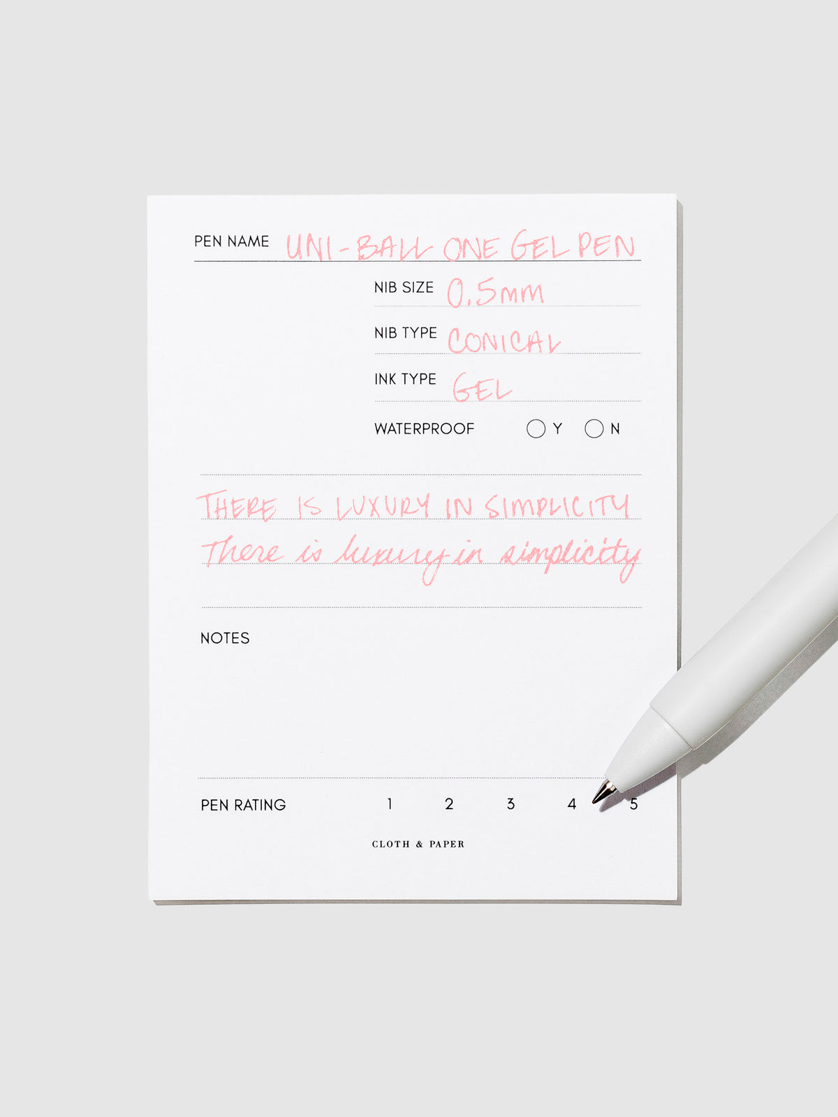 Pen tilted slightly to the right on a neutral background. Color pictured is Poppy Red.