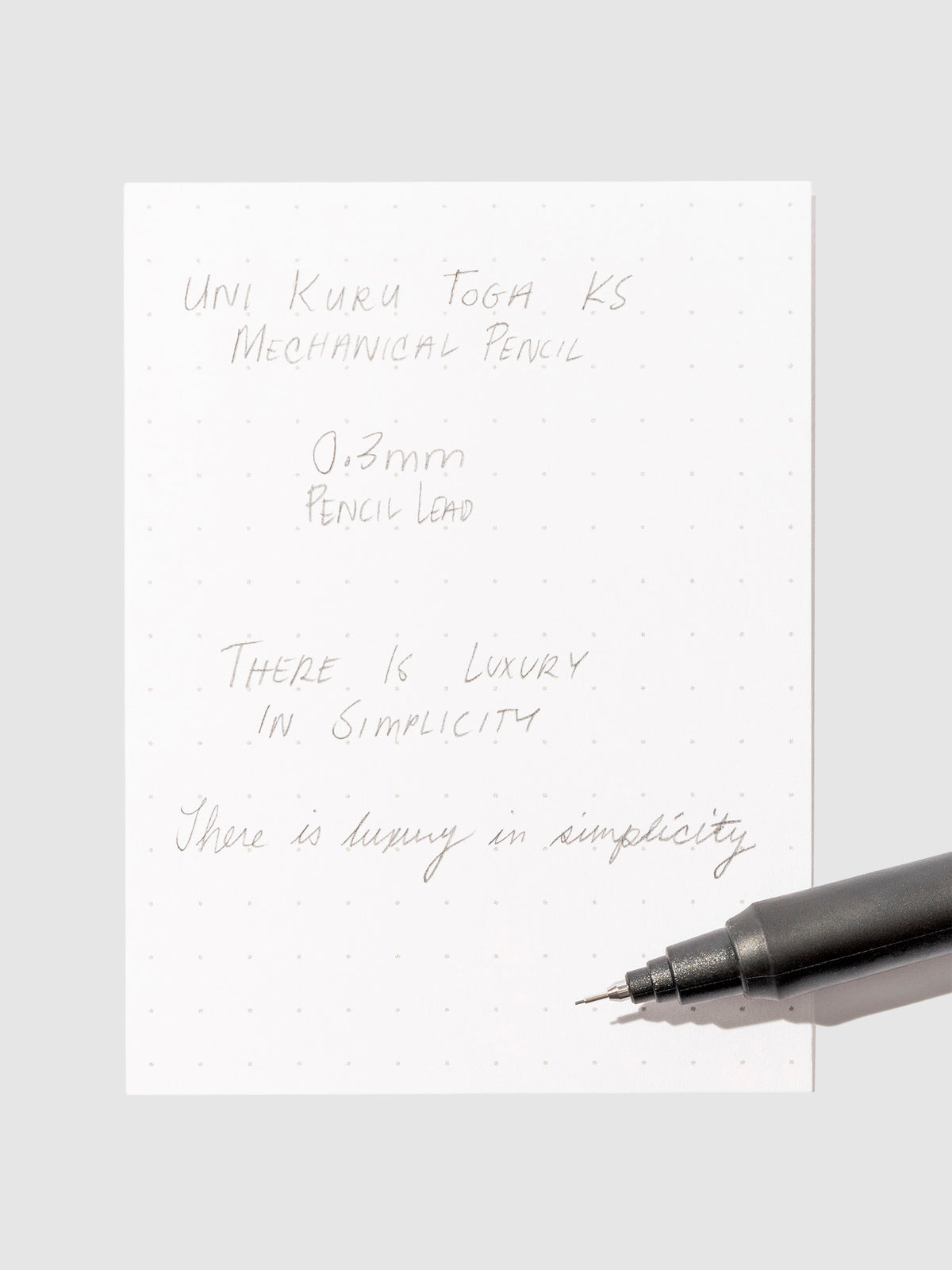 Pen testing sheet in use on a neutral background.
