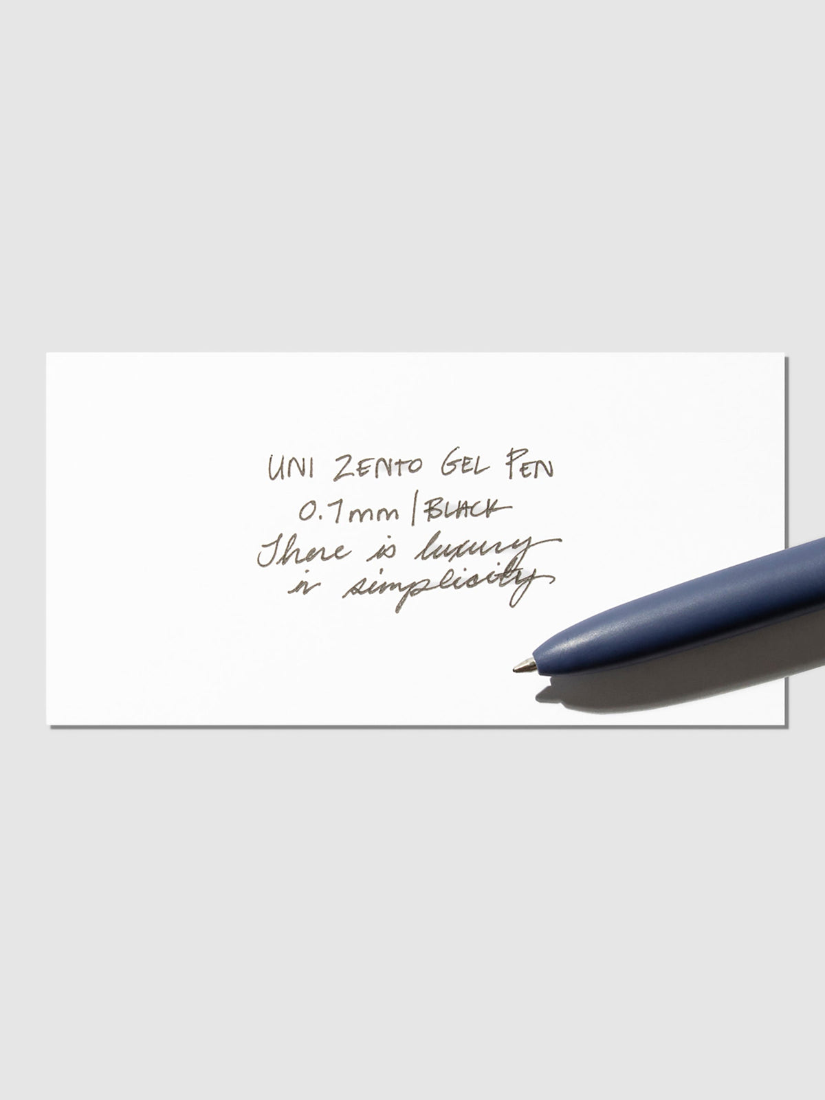 Writing sample shown with pen resting on the testing sheet. Color shown is Coastal.