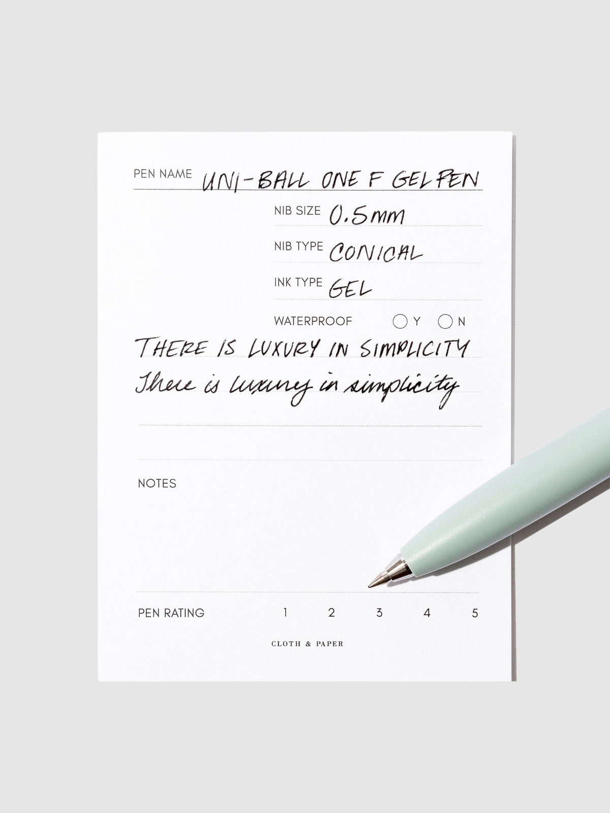 Green pen resting on an in use pen test sheet.