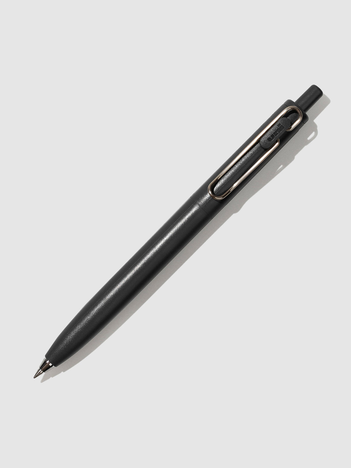 Dark Grey pen turned to the right against a neutral background.