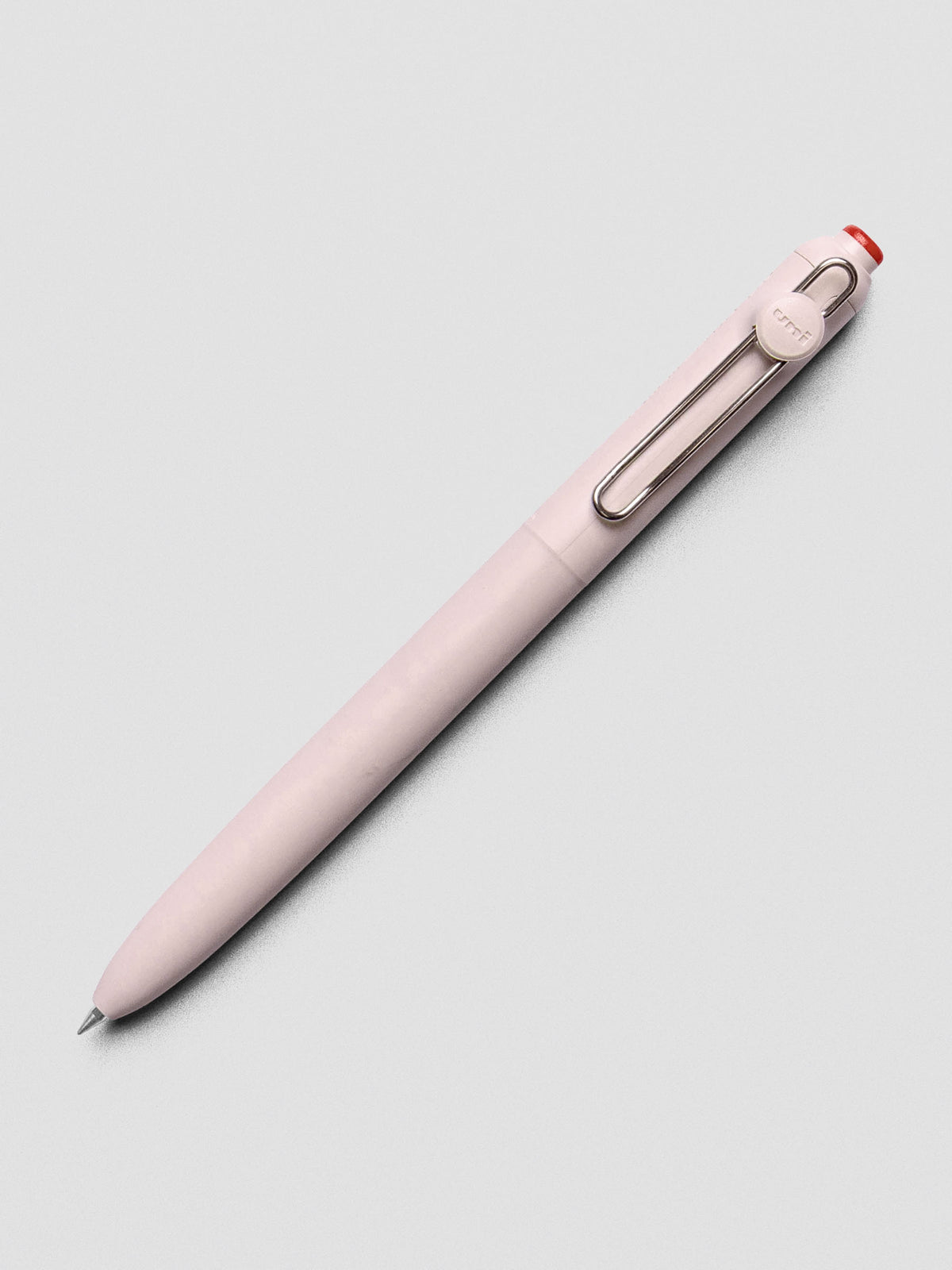 Pink/red pen shown at an angle with a silver clip.