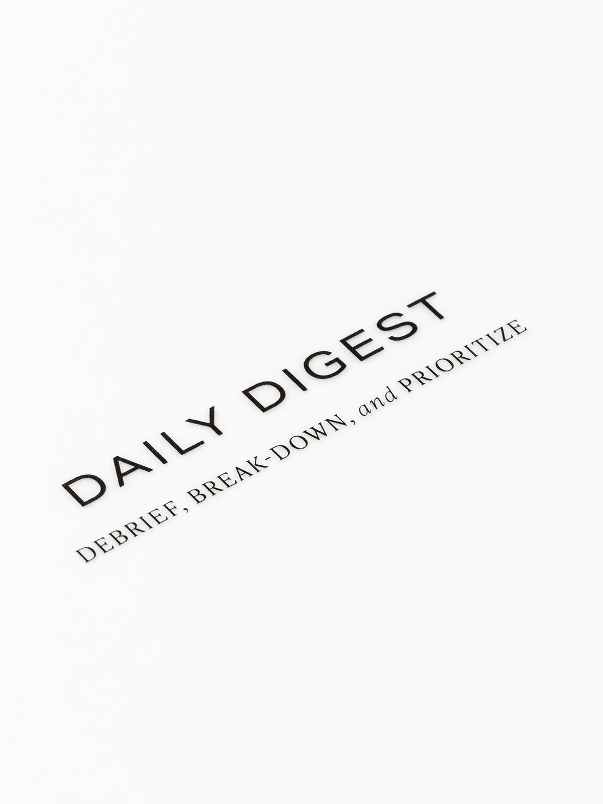 Closeup of text reading "daily digest | debrief, break-down, and prioritize"