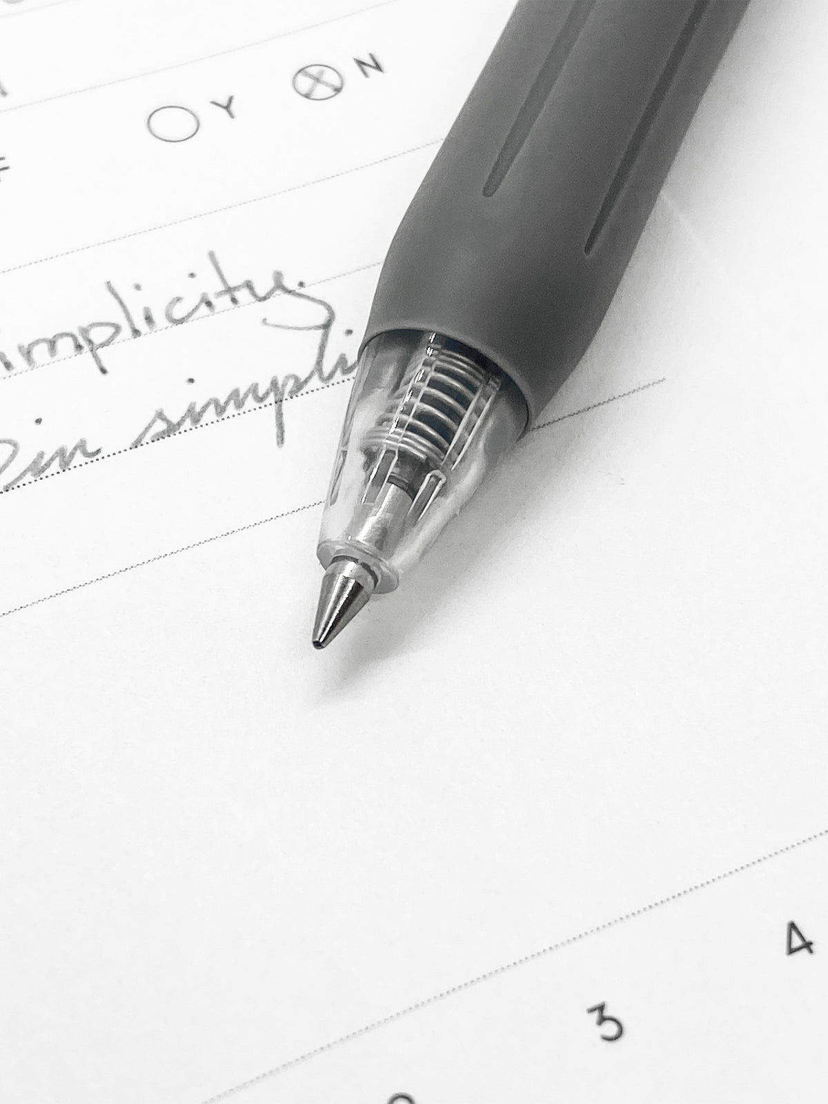 Zebra Sarasa Clip, 0.5 mm, Gray, Cloth and Paper. Close up on pen nib and writing sample.