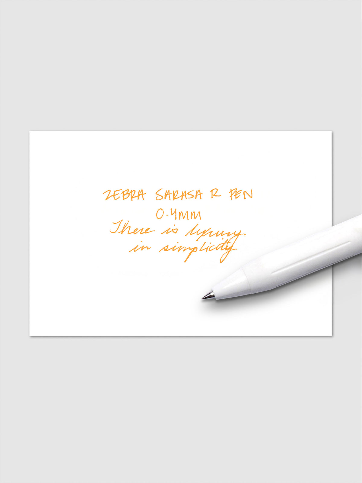 Writing sample using Zebra Sarasa R 0.4mm pen in orange ink on white paper.