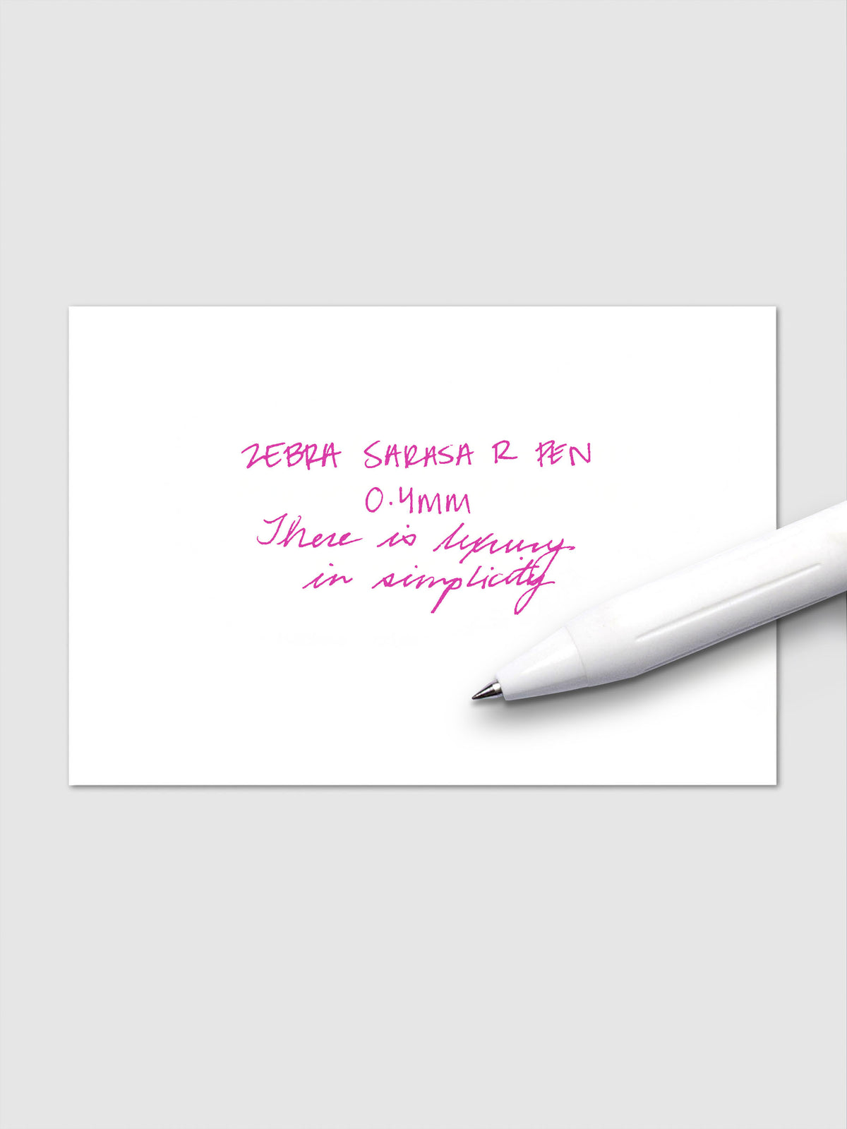 Writing sample using Zebra Sarasa R 0.4mm pen in pink ink on white paper.