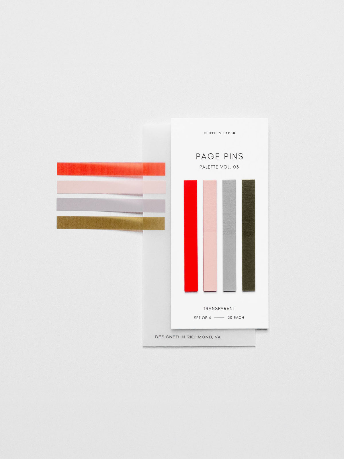 Page pins displayed on a neutral background. One of each of the four colors is displayed on the side of the packaging, showcasing its transparency.