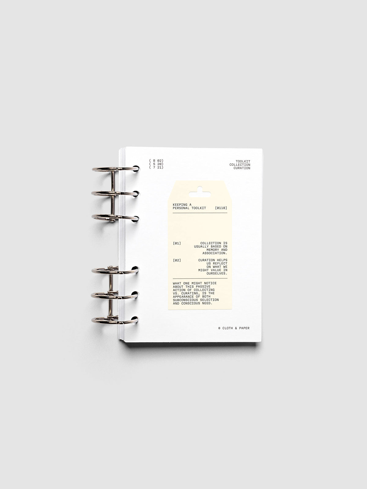 Personal Toolkit Planner Dashboard in A6 6-Ring Punch, a cardstock dashboard with an affixed warm gray printed tag in black type on a light gray background