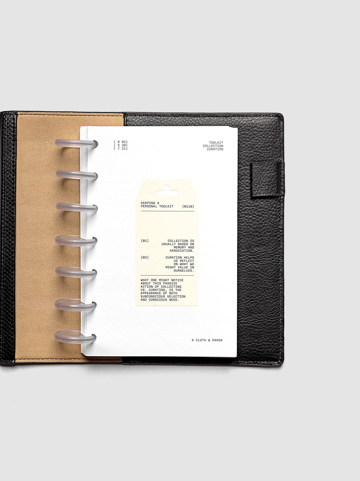 Personal Toolkit Planner Dashboard in HP Mini 7-Disc Punch, a cardstock dashboard with an affixed warm gray printed tag in black type on a light gray background
