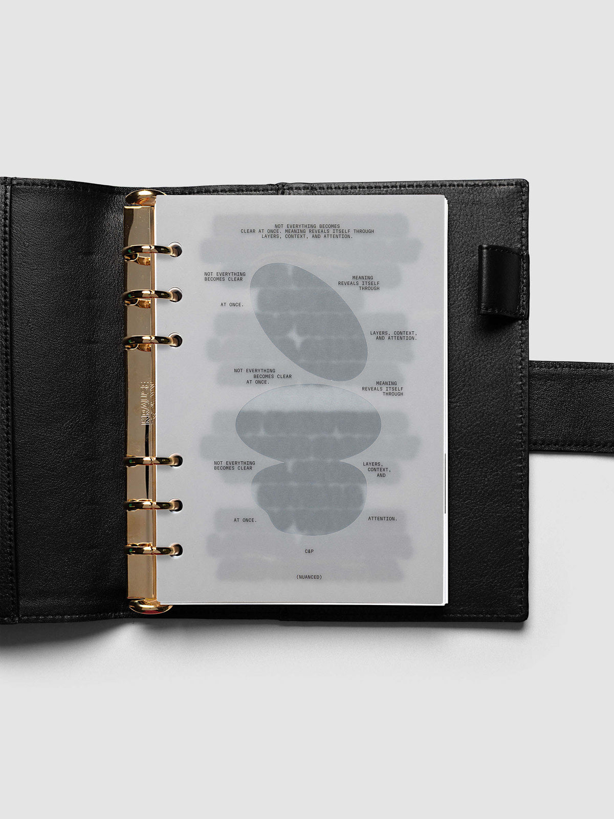 Nuanced Dashboard Trio, Personal Wide 6-Ring Punch, dashboard on the gold rings of an open black leather planner