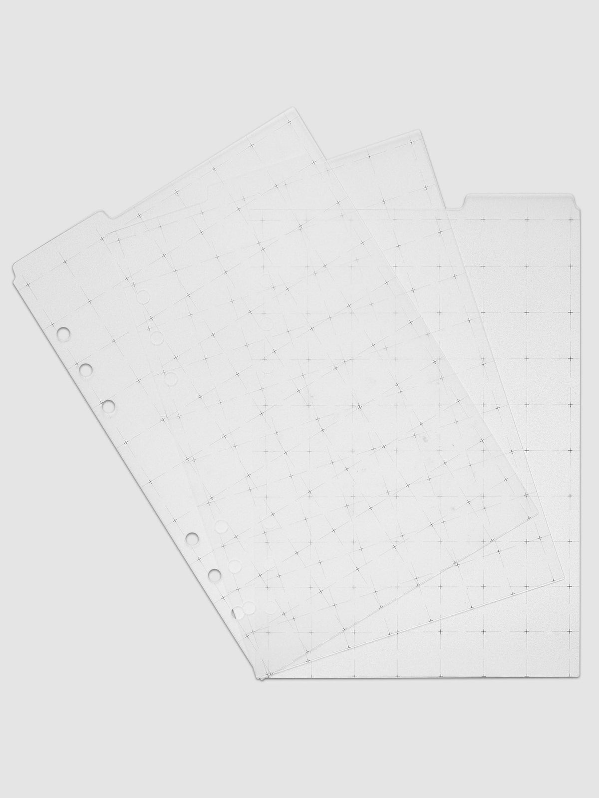Grid Top Tab Dividers | Ultra-Thin, A5 6-Ring Punch, the set of three fanned at an angle so each tab position shows, black grid print visible through the translucent white plastic onto the sheets below