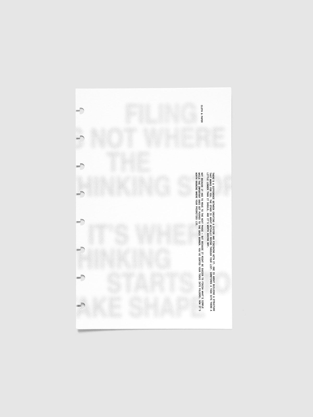 Halftone Planner Dashboard, Half Letter 8-Disc Punch, white dashboard lying flat, soft grey halftone headline with a column of black typewriter text at the right
