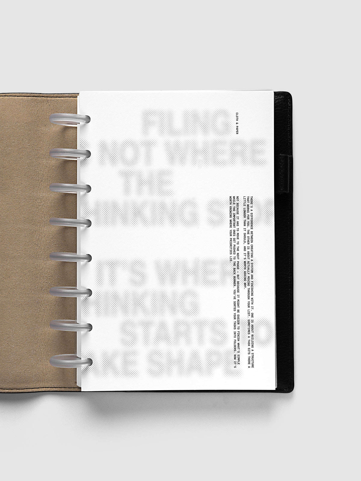 Halftone Planner Dashboard, Half Letter 8-Disc Punch, dashboard on frosted discs in an open black leather planner with a kraft interior panel