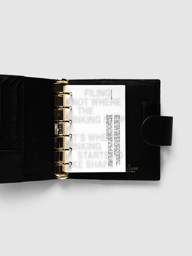 Halftone Planner Dashboard, Pocket 6-Ring Punch, dashboard on the rings of an open black leather planner, the grey halftone headline across the page