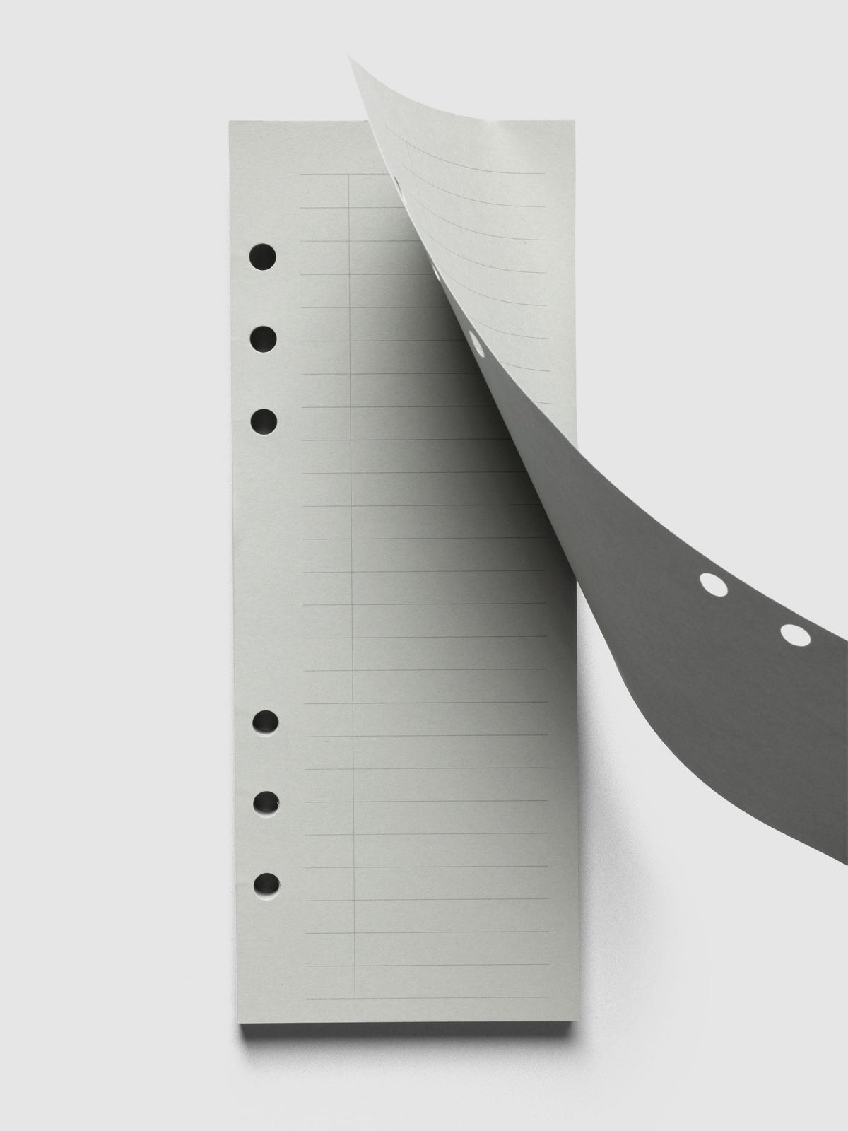 System Punch Pad, A5 6-Ring Punch, top sheet peeling back from the pad to show the pre-punched holes along its edge