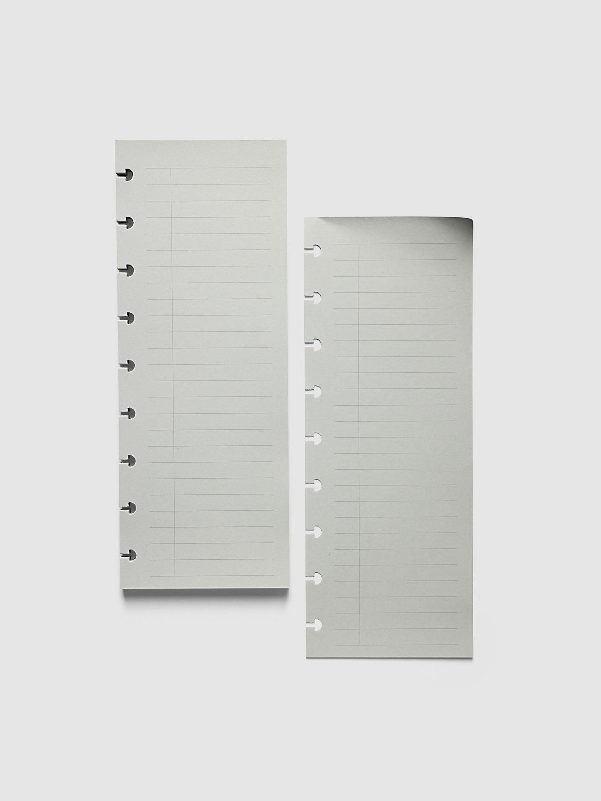 System Punch Pad, A5 6-Ring Punch, a torn-off sheet lying beside the pad, round ring holes along the left edge of each