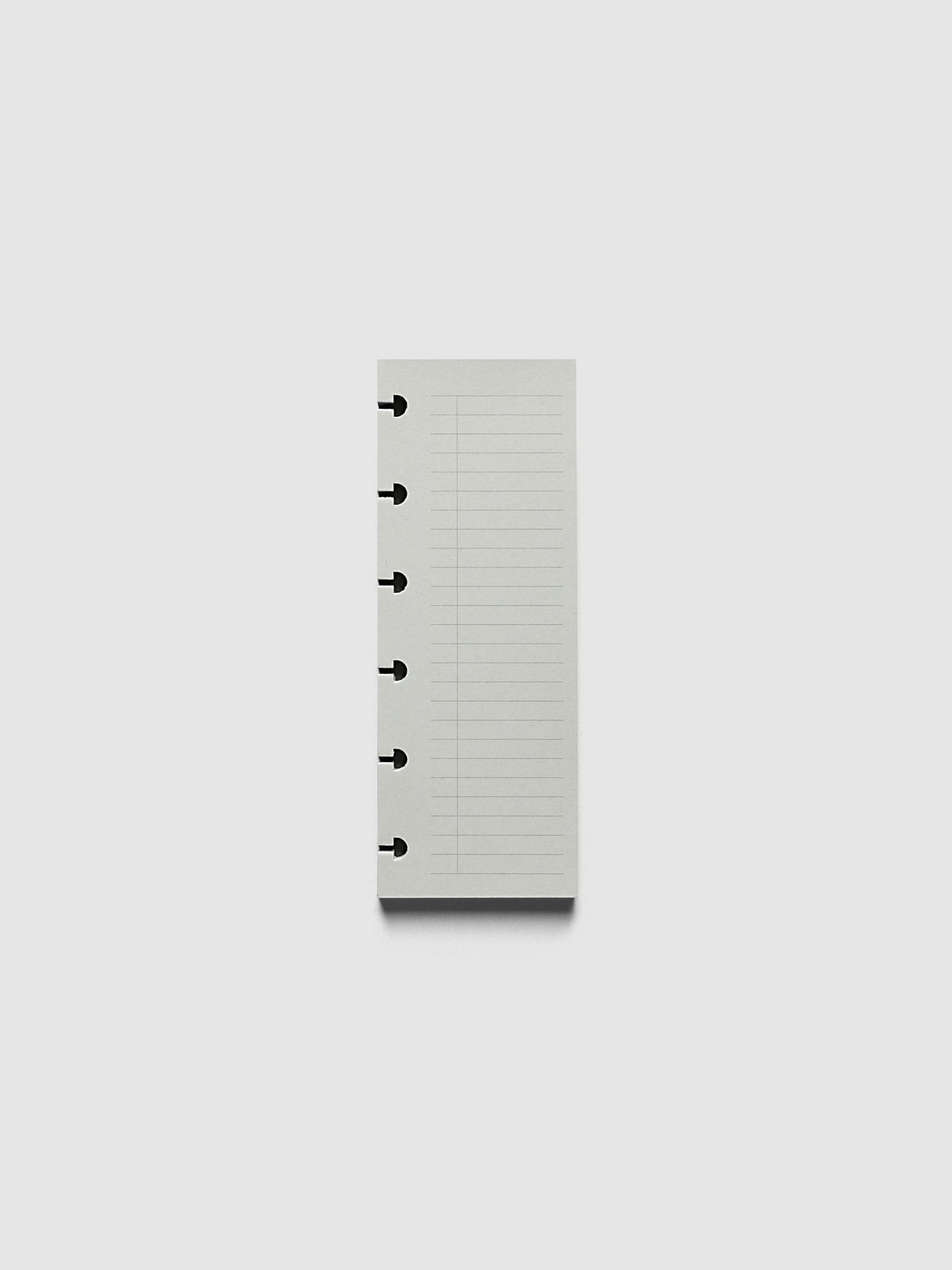 System Punch Pad, CP Petite 6-Disc Punch, pale grey pad of ruled task list sheets lying flat, disc notches along the left edge