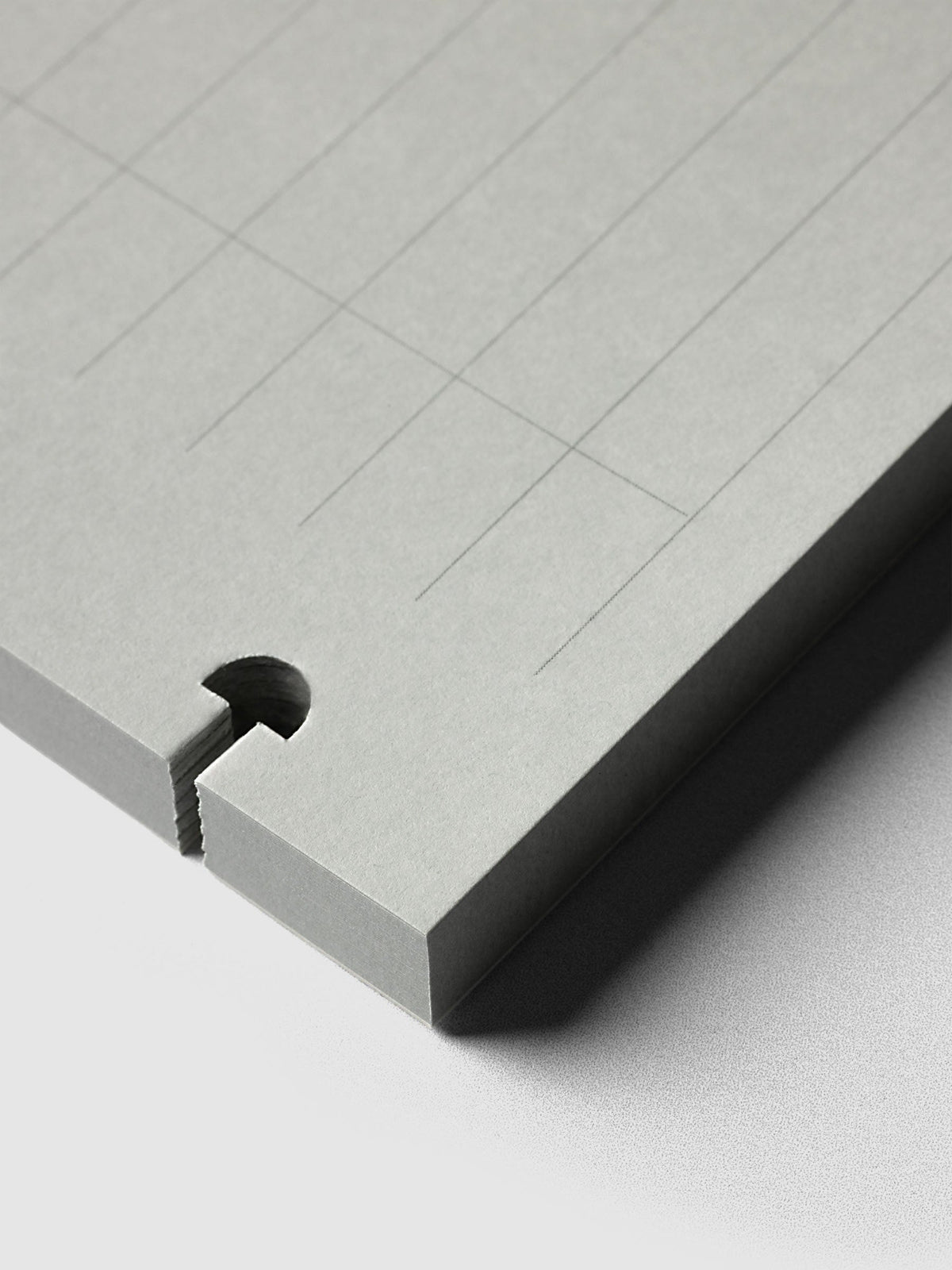System Punch Pad, close-up of a disc notch cut through the corner of the pad