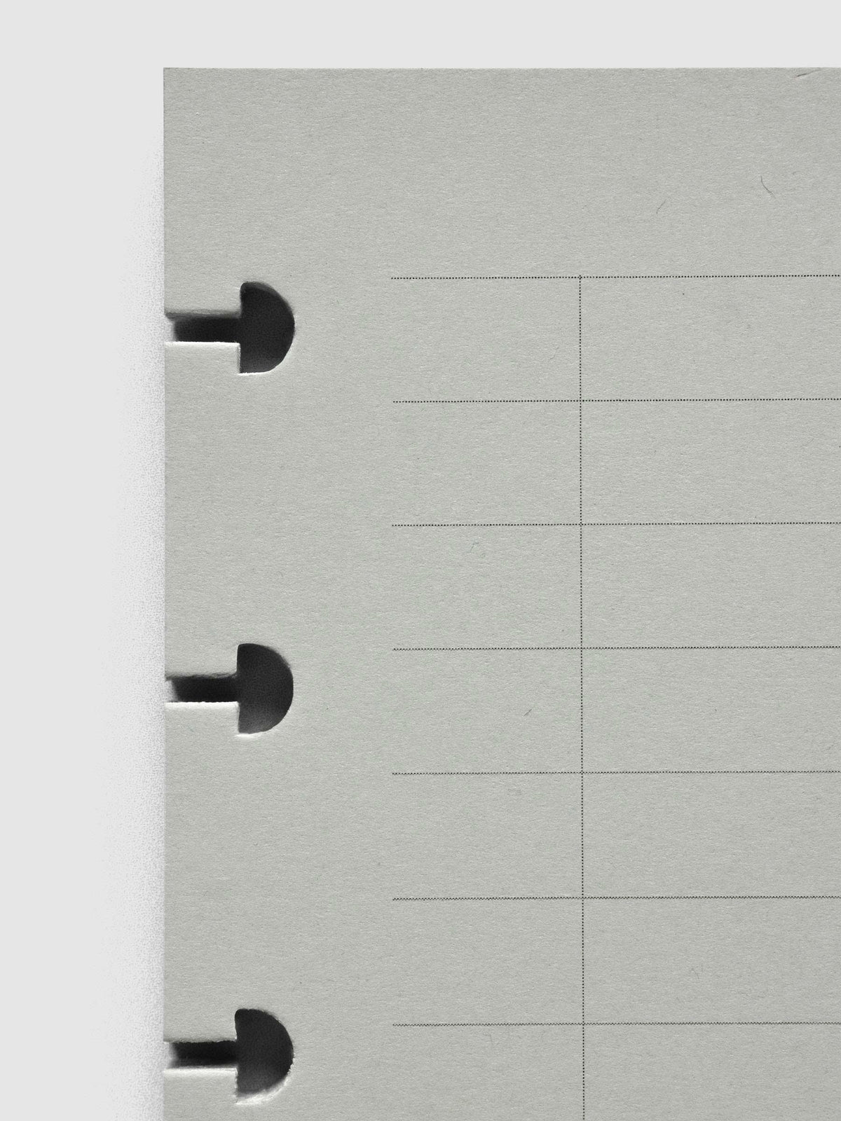 System Punch Pad, close-up of the disc notches along the edge of a sheet