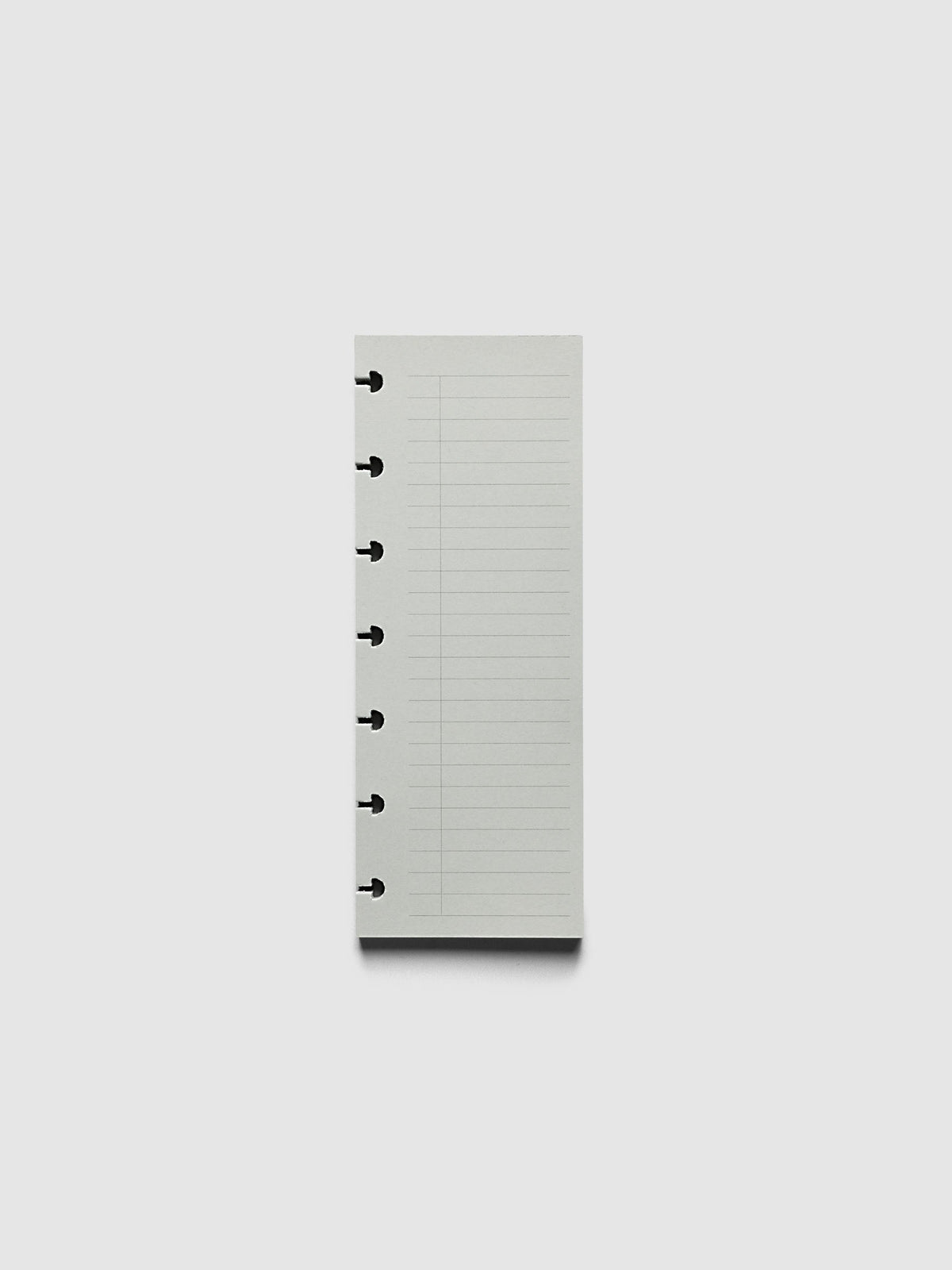 System Punch Pad, HP Mini 7-Disc Punch, pale grey pad of ruled task list sheets lying flat, disc notches along the left edge