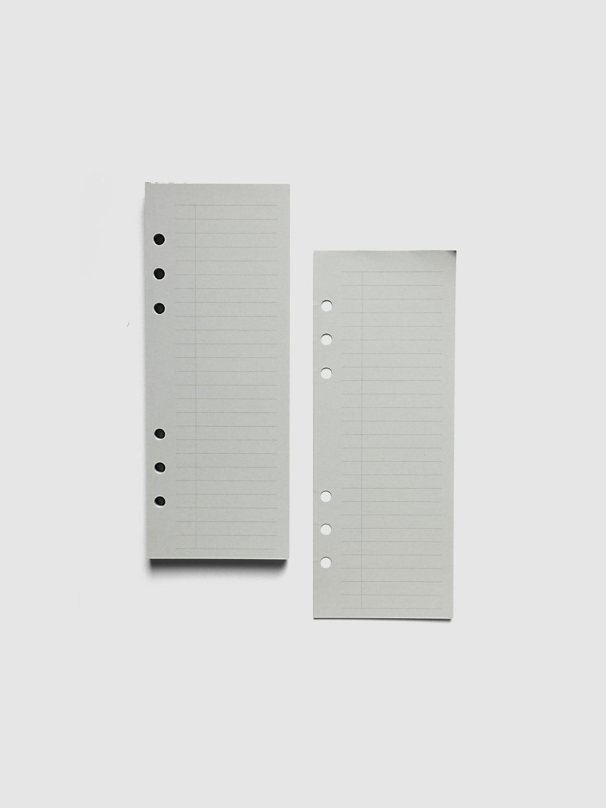 System Punch Pad, Personal Wide 6-Ring Punch, a torn-off sheet lying beside the pad, round ring holes along the left edge of each