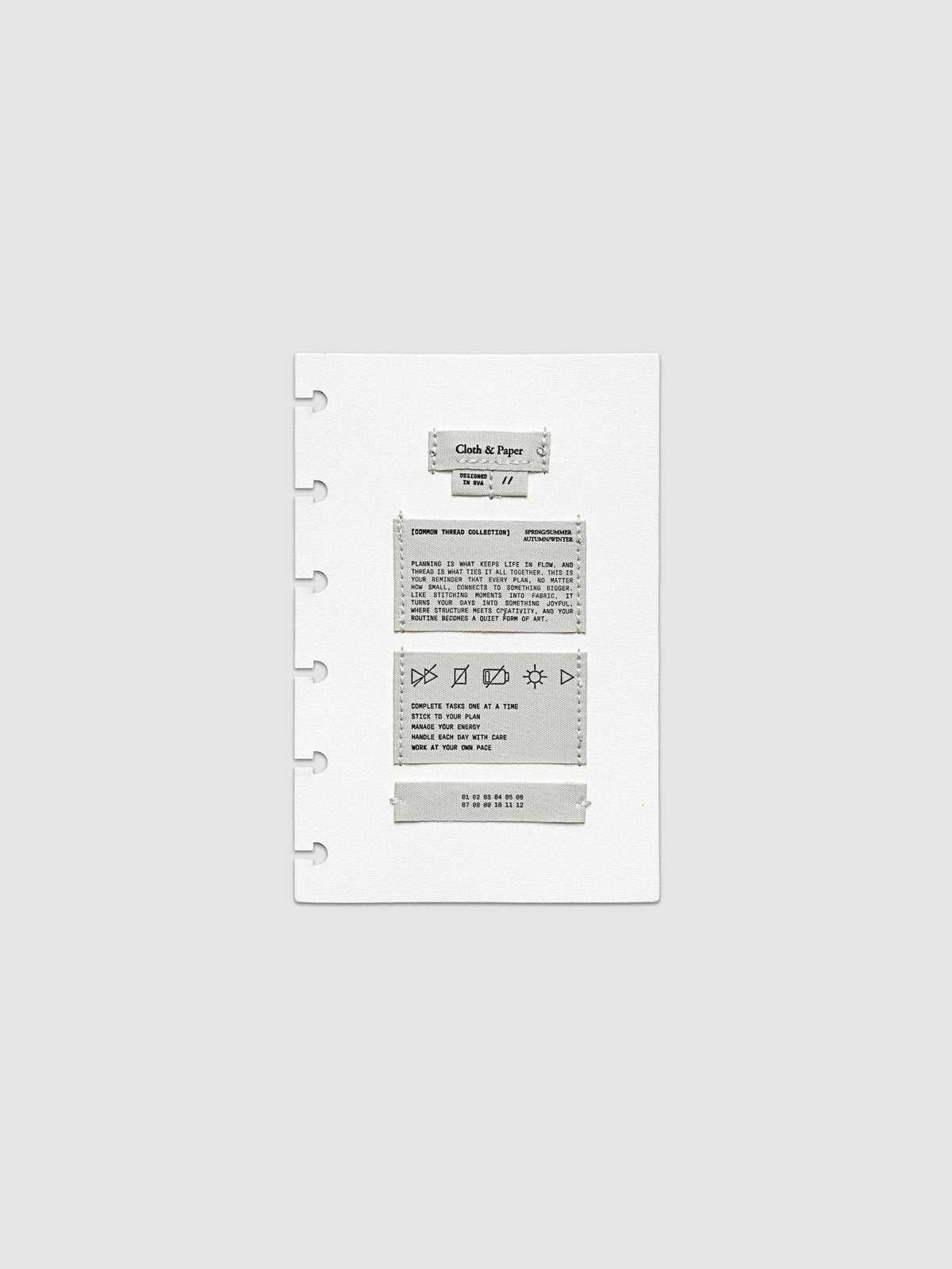 Sewn Tags Planner Dashboard shown pre-punched for discbound planners in size CP Petite.