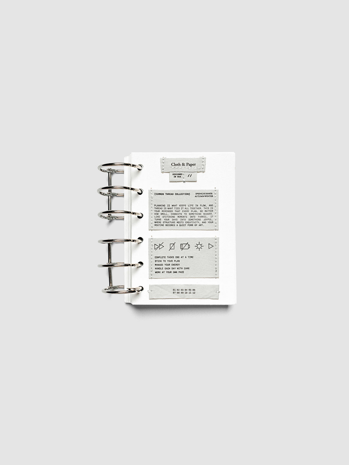 Sewn Tags Planner Dashboard pre-punched for 6-ring planners in size Pocket shown ring bound.