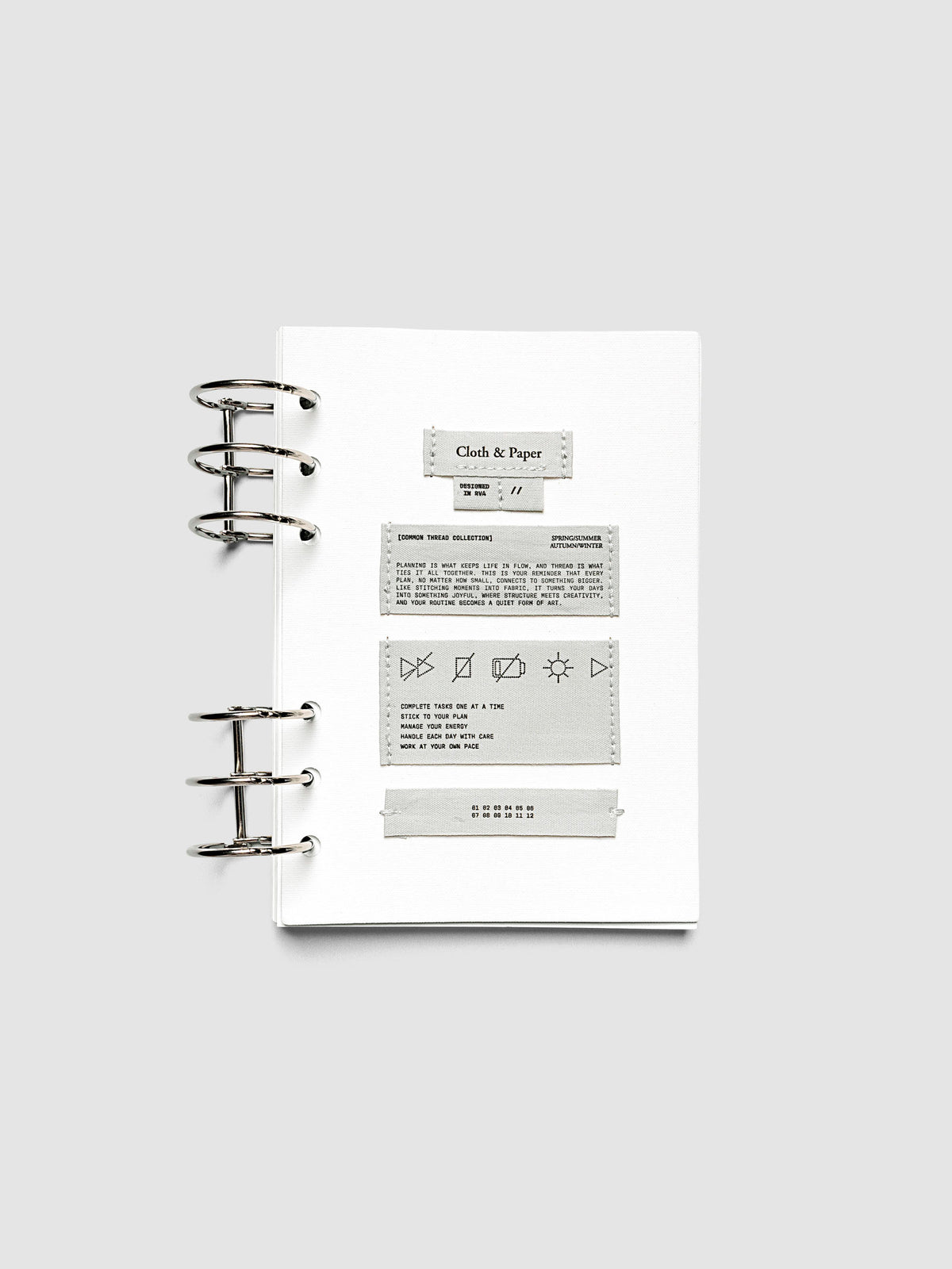 Sewn Tags Planner Dashboard pre-punched for 6-ring planners in size A5 shown ring bound