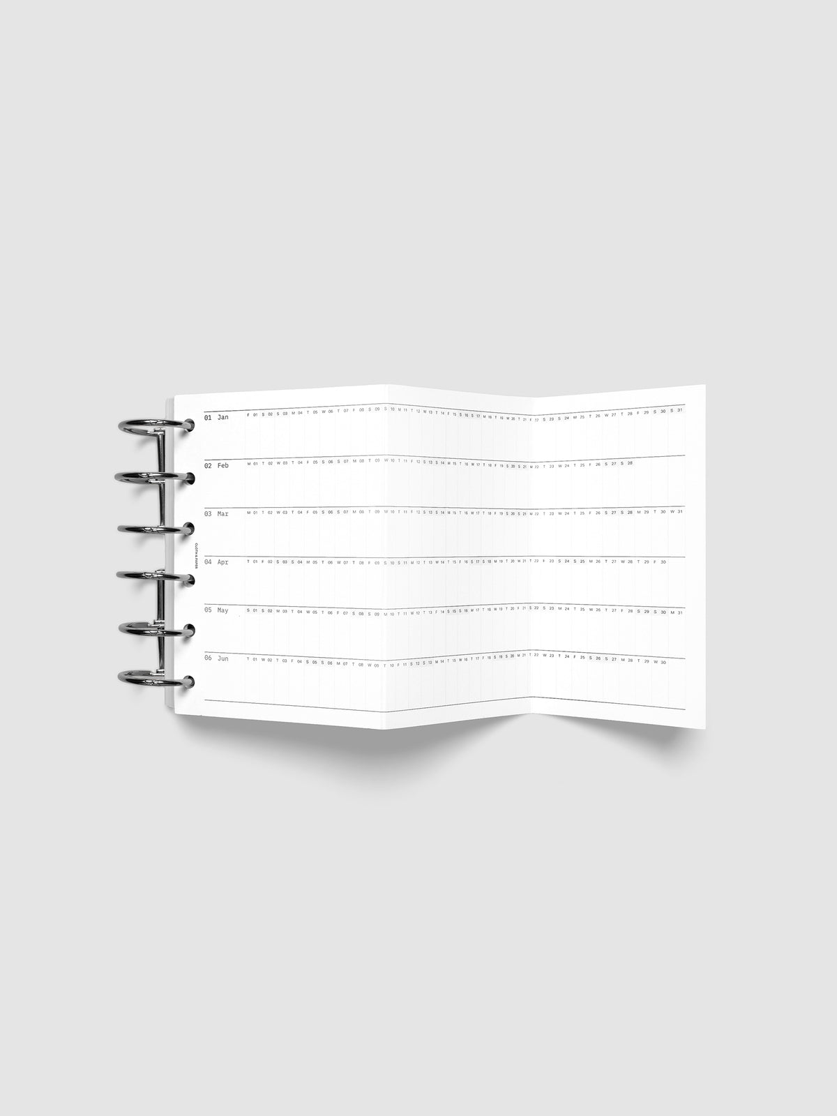 2027 Dated Fold Out Insert fully unfolded inside a Pocket 6-Ring Punch 6-ring planner, showing six months of dated calendar boxes across one side.