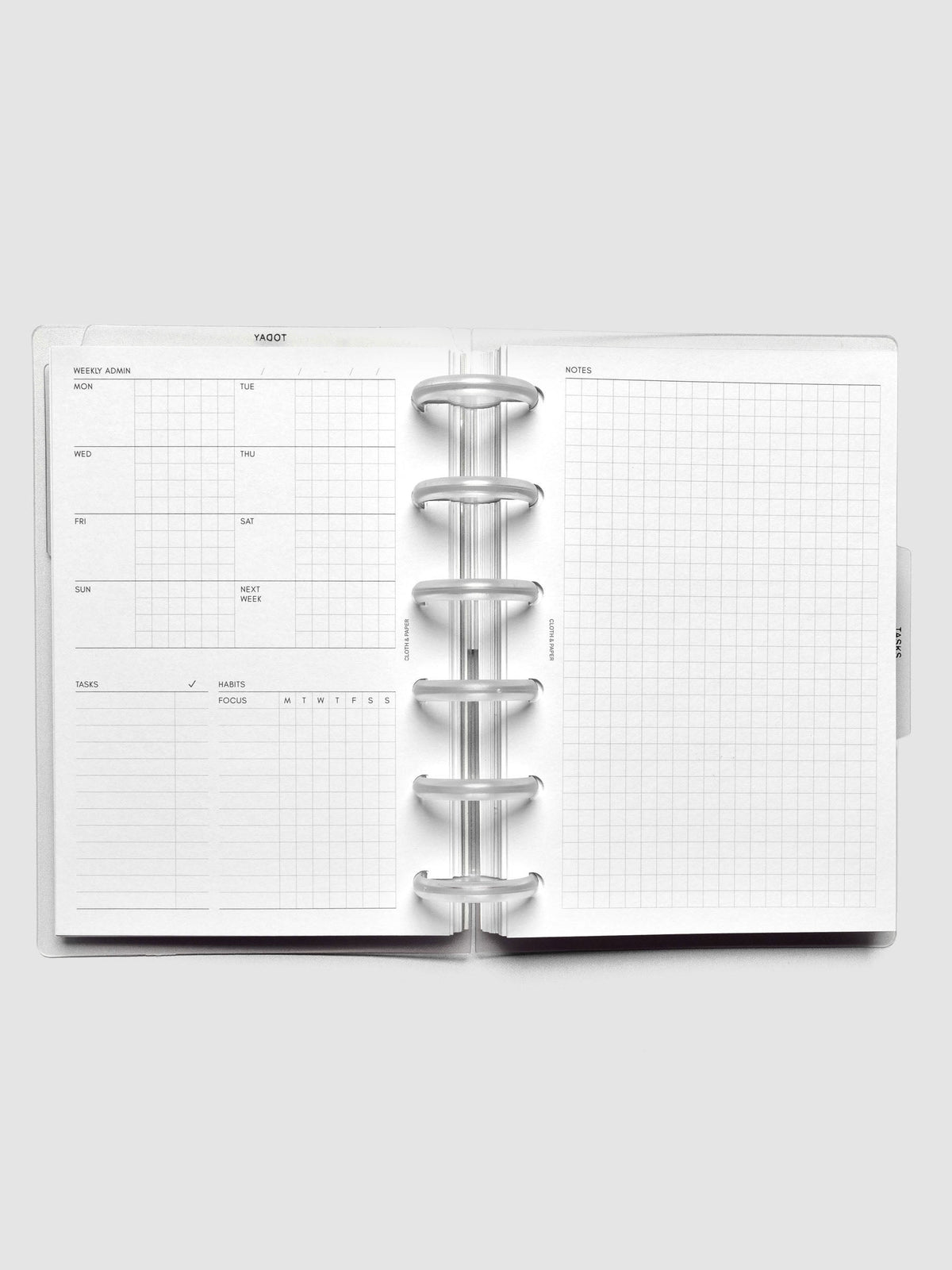 Open discbound planner showing a undated monday start weekly admin page on the left and a graph notes page on the right.