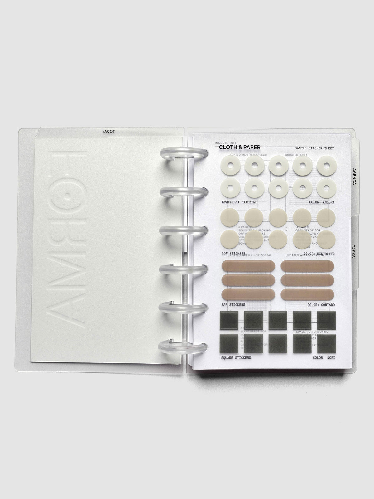 Open discbound planner displaying sticker sheet with four shapes and colors of stickers.