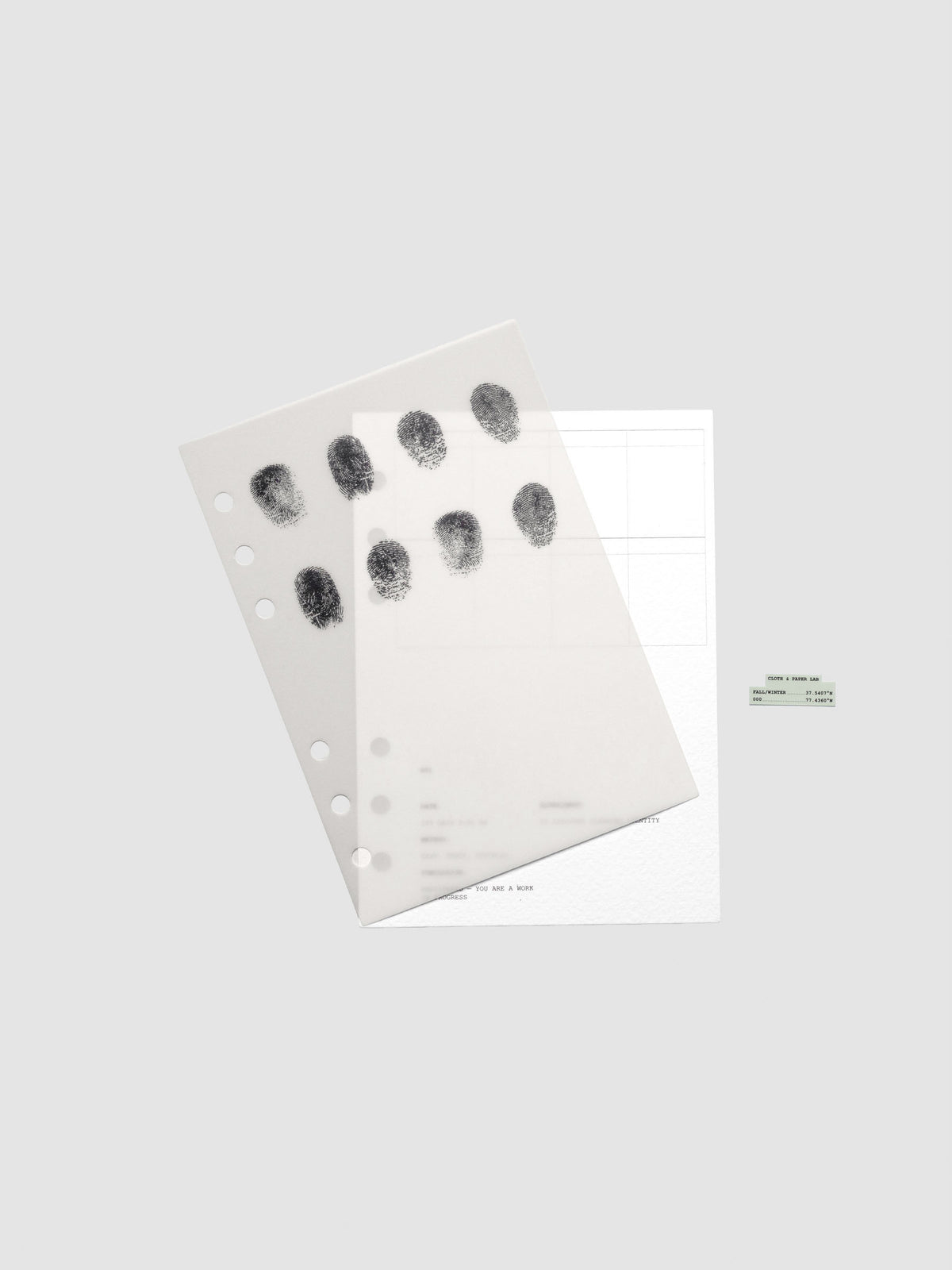 Two layered Personal Wide sized planner dashboards, one semi-transparent, one matte, featuring a fingerprint design shown offset from one another.
