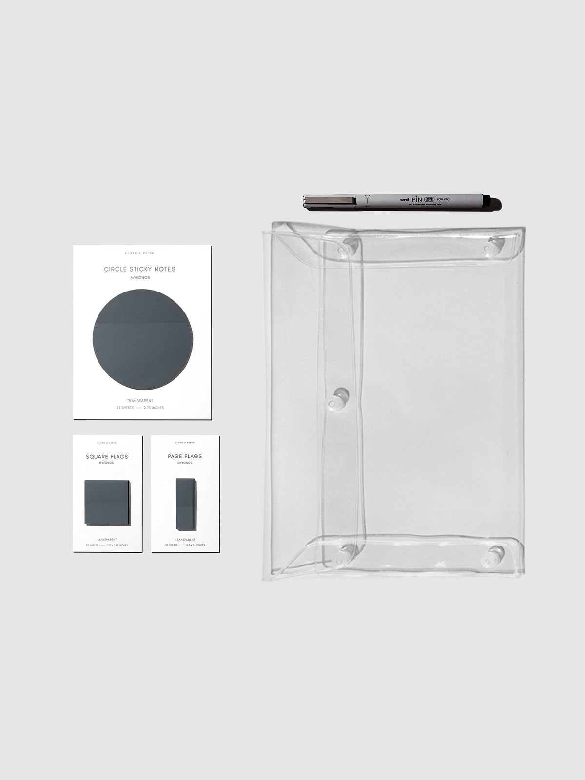 Matching set of circle sticky notes, page flags, and square page flags positioned next to a Uni Pin Marking Pen and Essentials Clear pouch. Sticky note color is Mykonos.