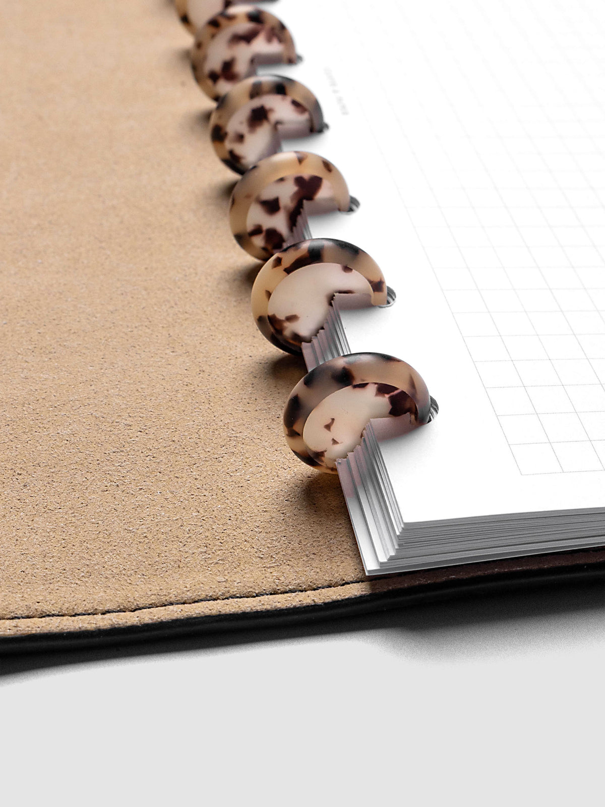 0.75" Inch Desert Tortoiseshell Planner Discs shown in use as binding with planner inserts.