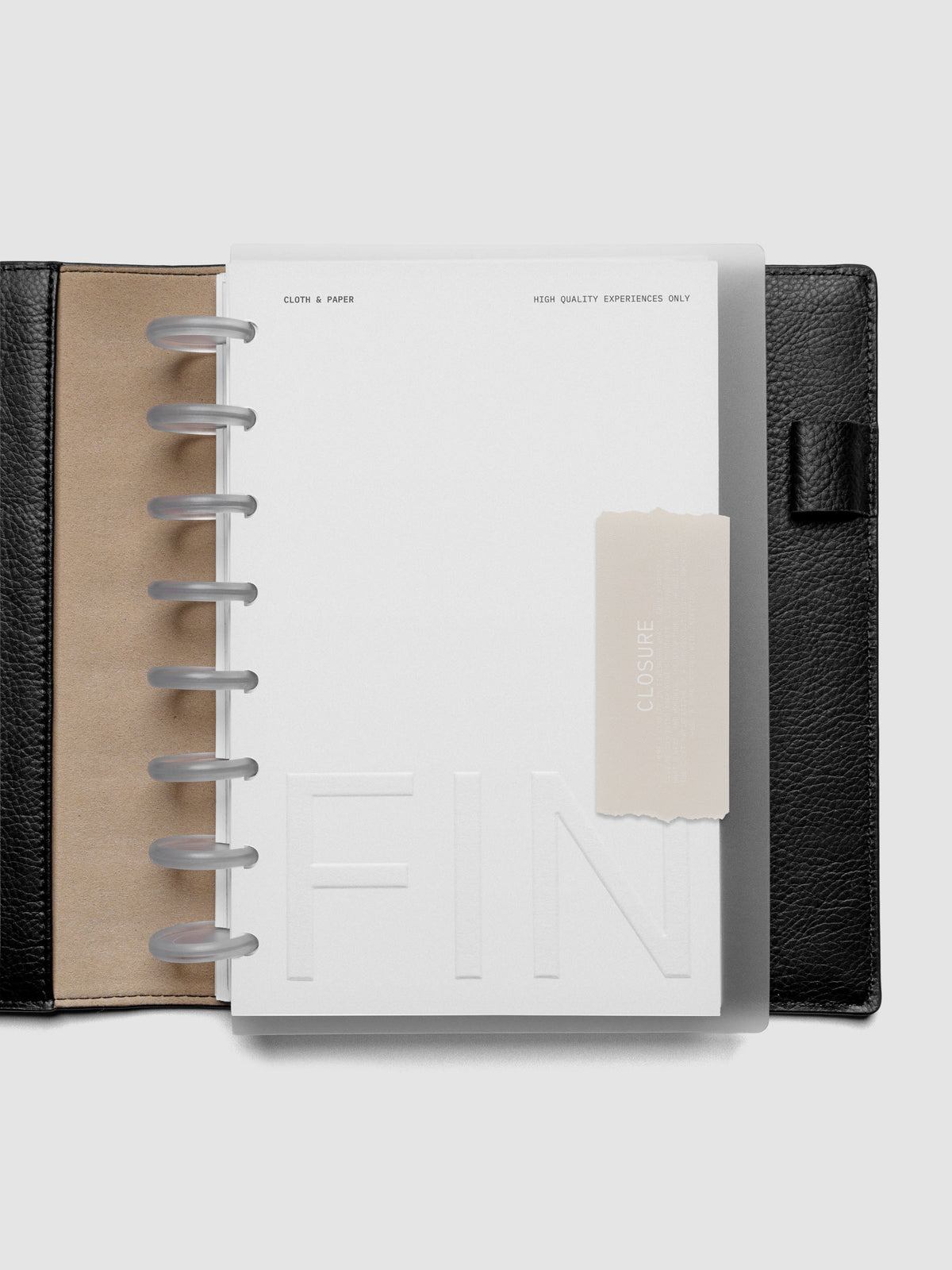 Closure Planner Dashboard + Cover Set in size Half Letter shown discbound in a black leather folio cover.