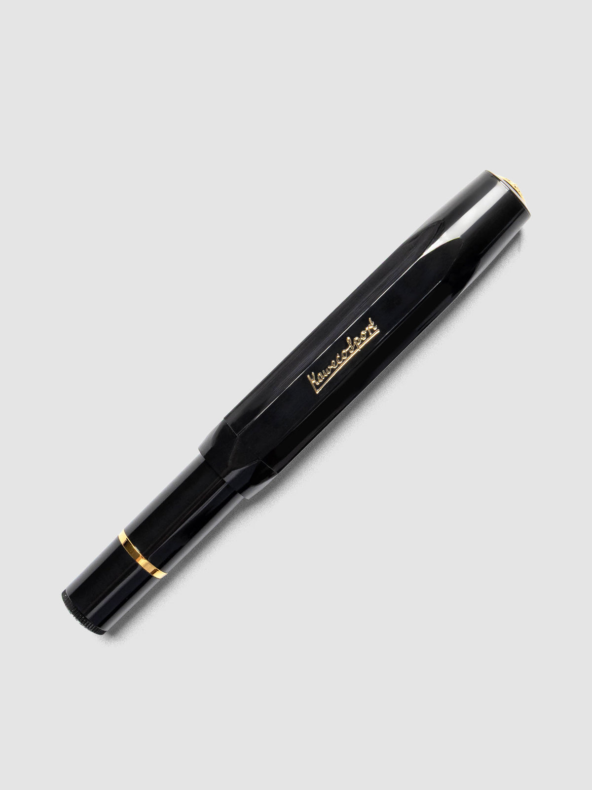 Black fountain pen with gold details shown capped.