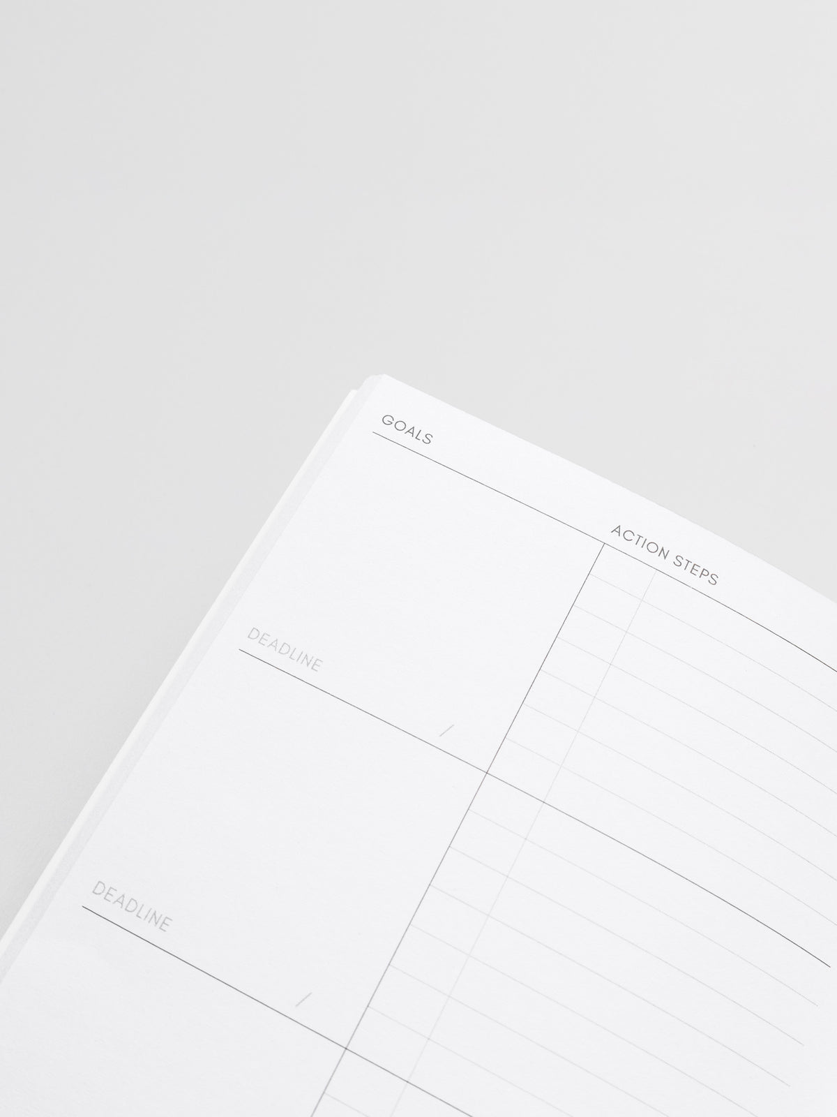Interior of Goal Tracking Travel Notebook in size Pocket Plus displaying a two column layout in blank and task with fields for goals, deadlines, and action steps.