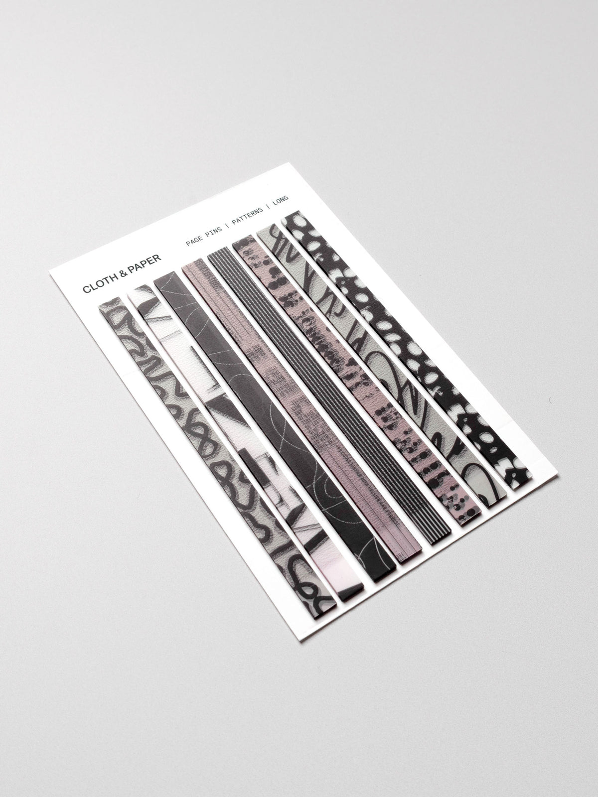 Long page pins displayed in their packaging on a neutral background.