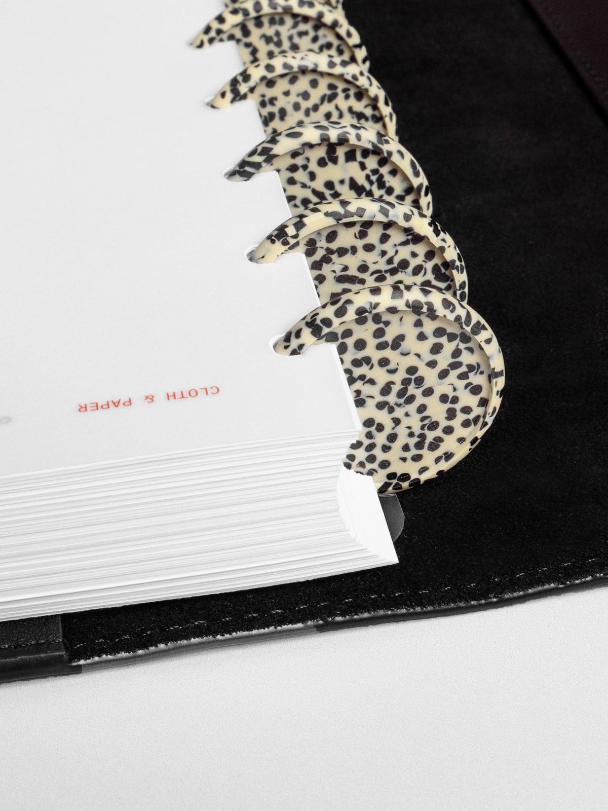 Closeup of discs inside a leather planner.