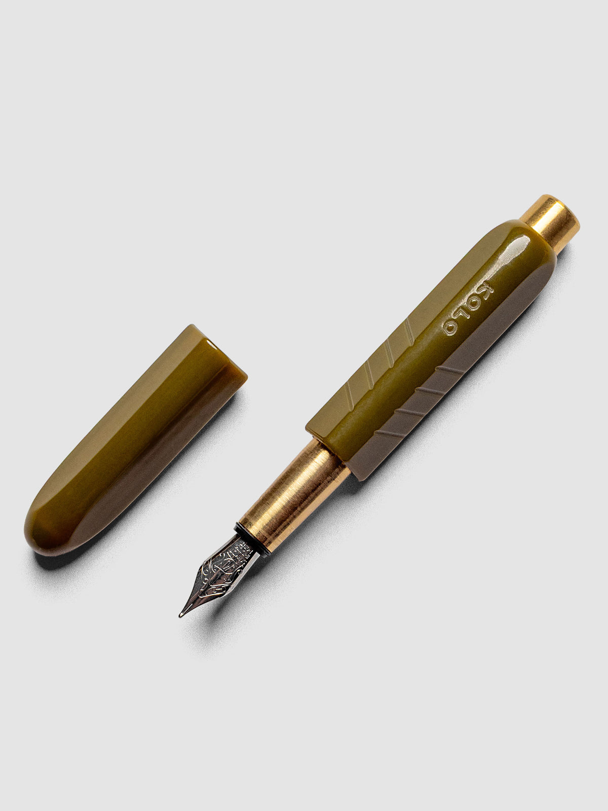 Kolo Tino Fountain Pen in the color Acrylic Wasabi, a warm green barrel with brass accents and a silver medium nib shown with cap off.