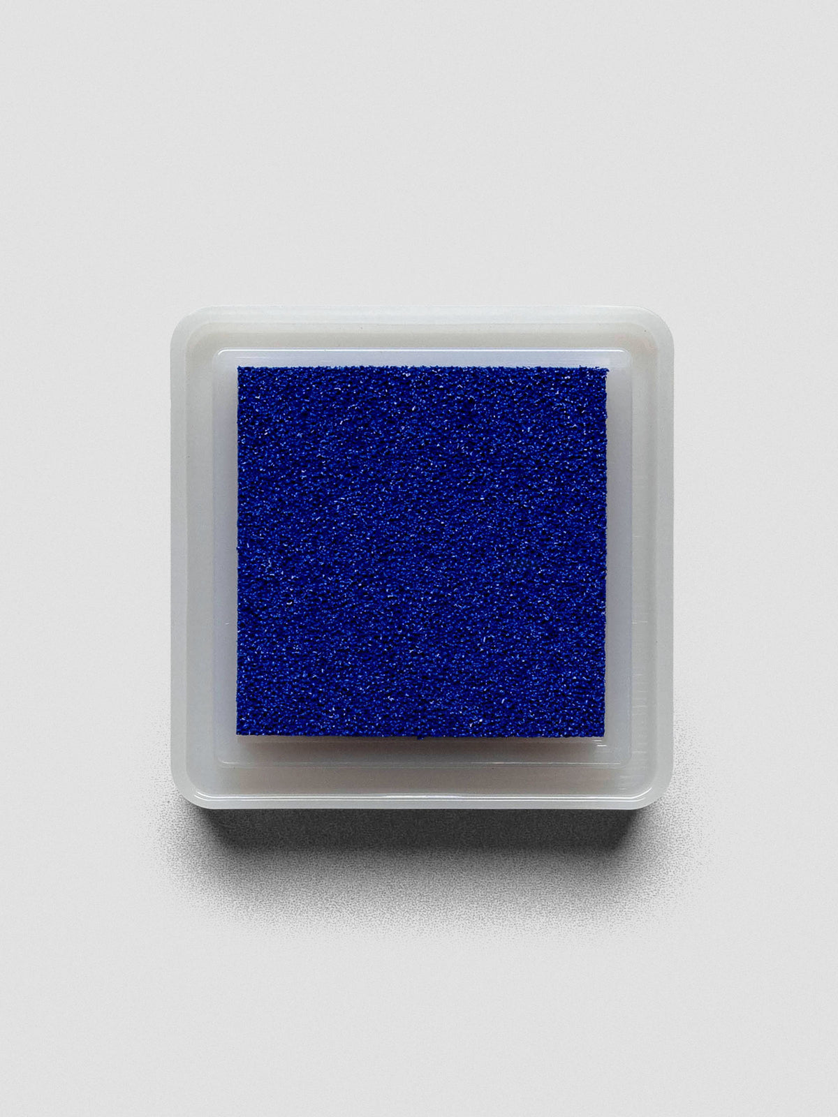 Blue Artnic ink pad without lid, top-down view showing textured ink surface.