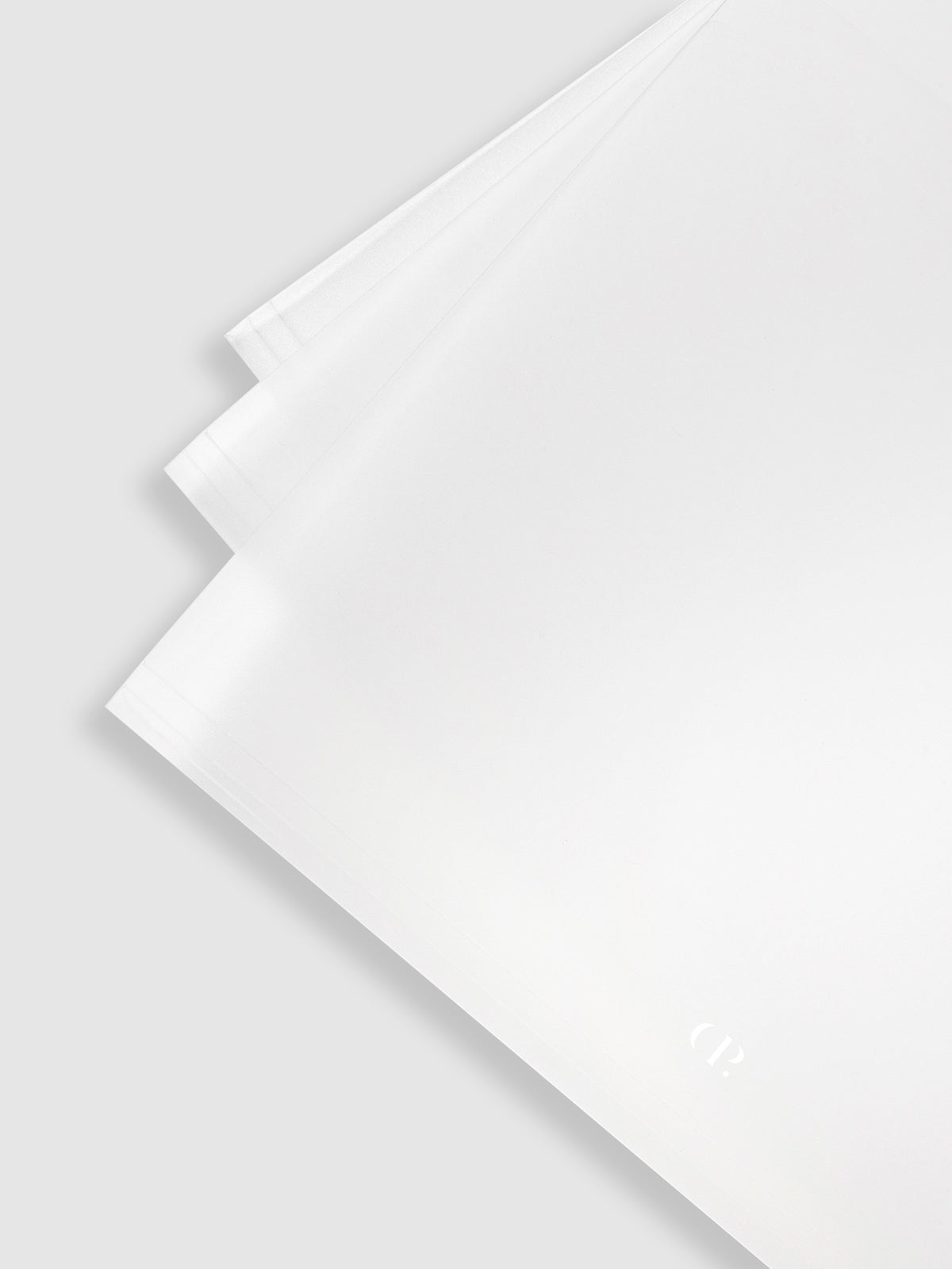 Close up of 3 folders layered on top of each other.