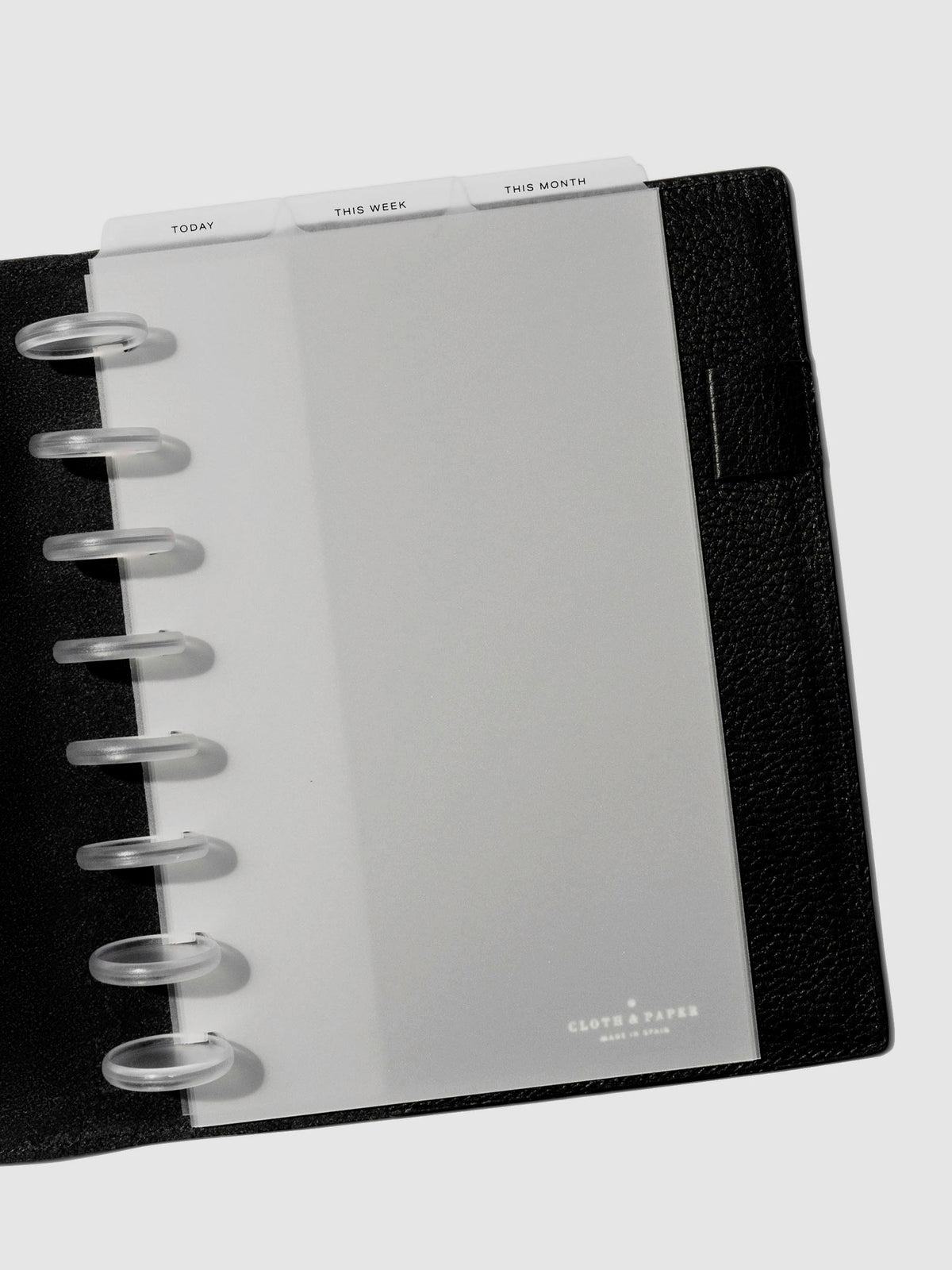 Half Letter Black Foil Cadence Tab Dividers displayed in a black leather planner.