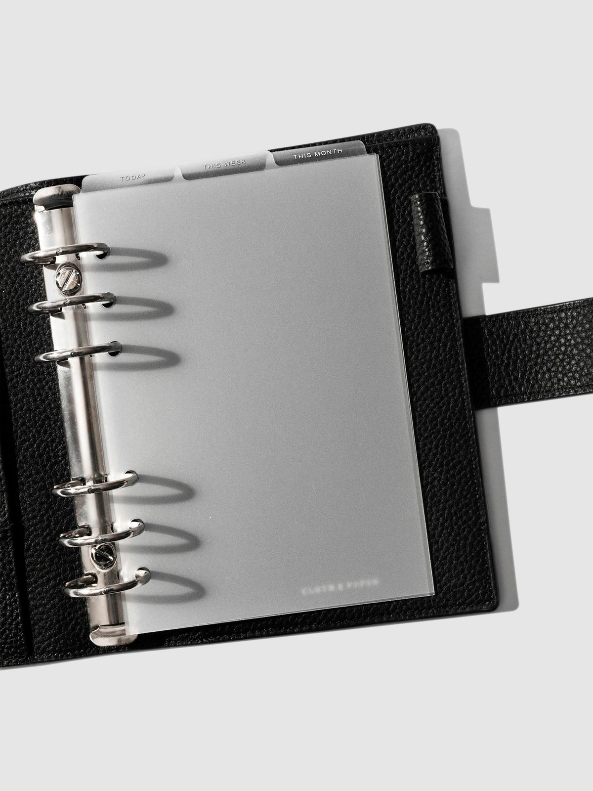 Personal Wide White Foil Cadence Tab Dividers displayed in a black leather planner.