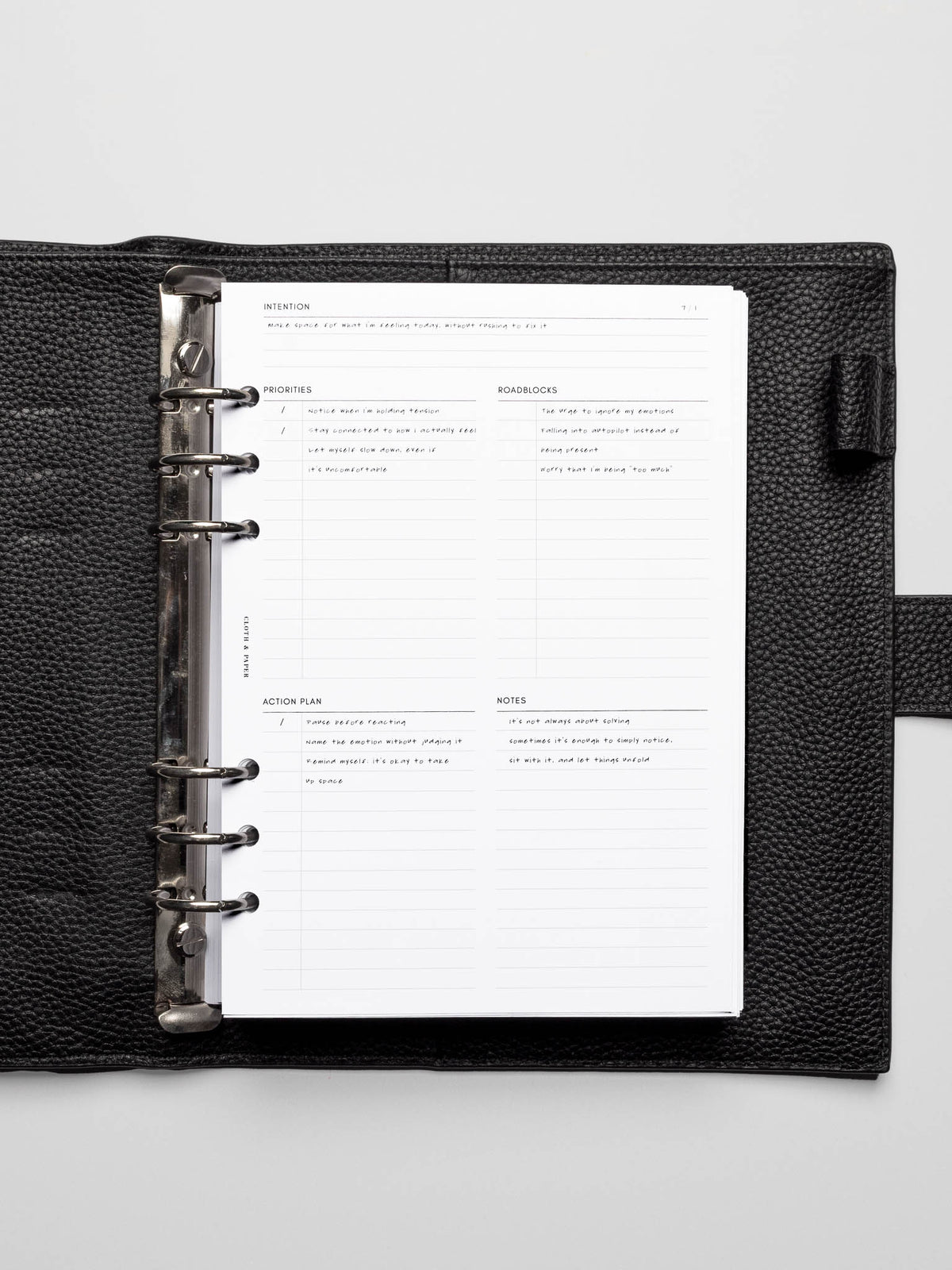 Daily Intention Planner Inserts in A5 size shown filled out in a leather agenda.