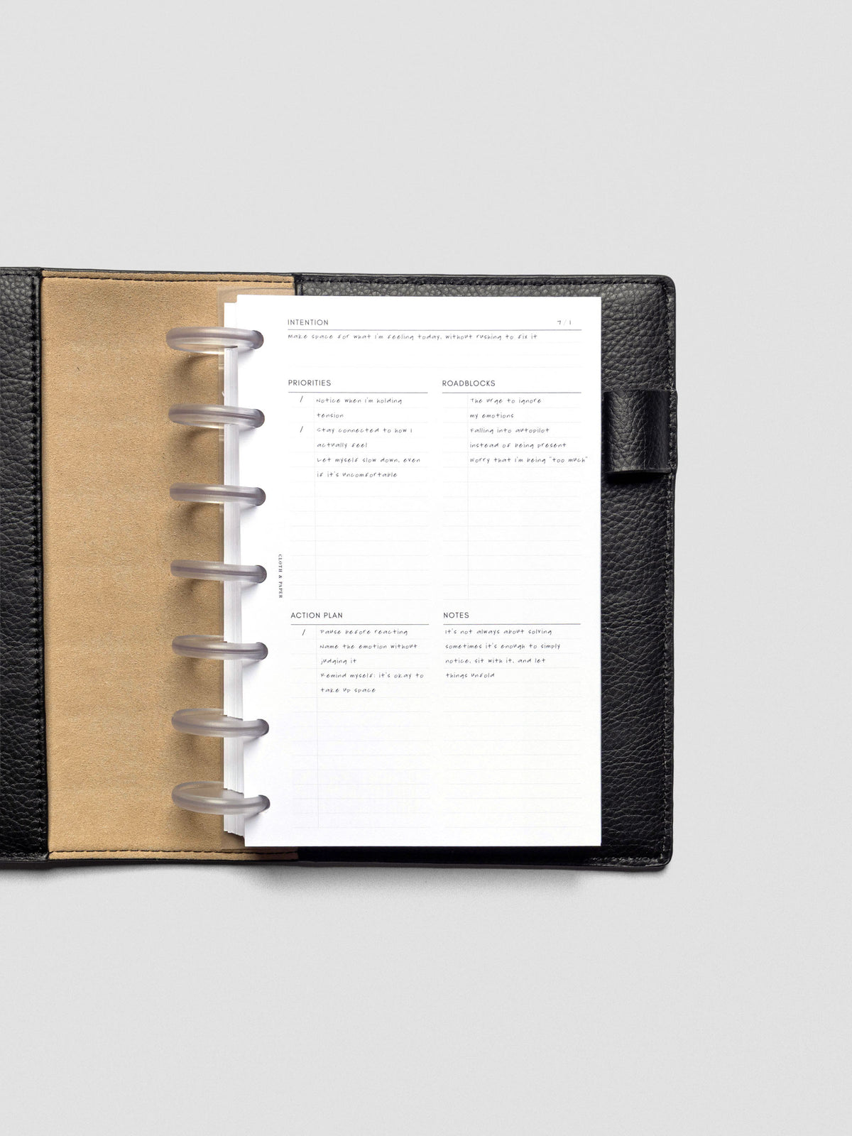 Daily Intention Planner Inserts show filled out in HP Mini size disc bound in a leather cover.