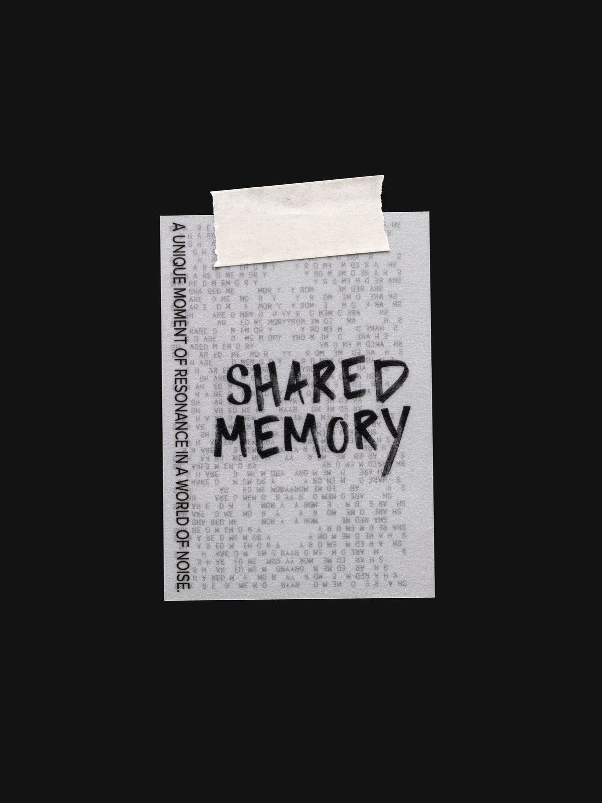 Translucent vellum journaling card with a black printed text design reading "Shared Memory" shown with tape on the top.