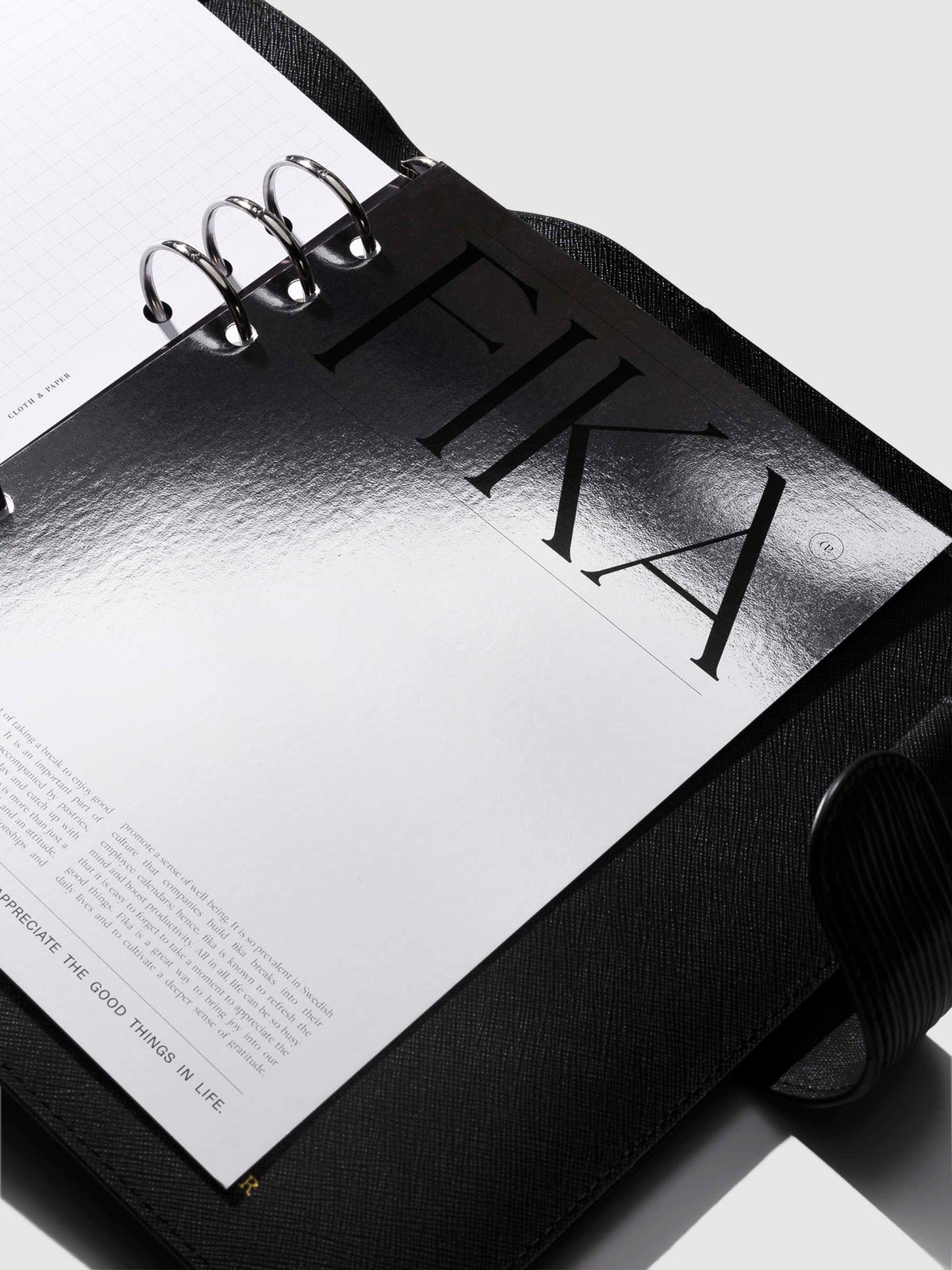 Dashboard in use inside a black leather agenda. Photo is angled in a way to show the dasboard's holographic reflective material.