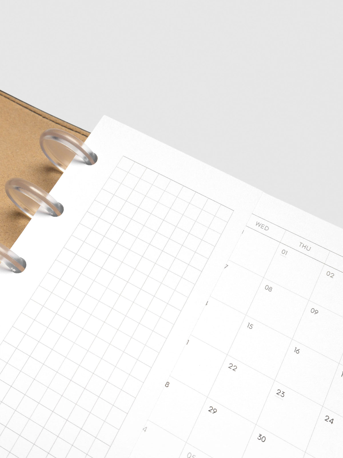 Close up of Half Page Inserts Graph inside discbound planner and leather cover.